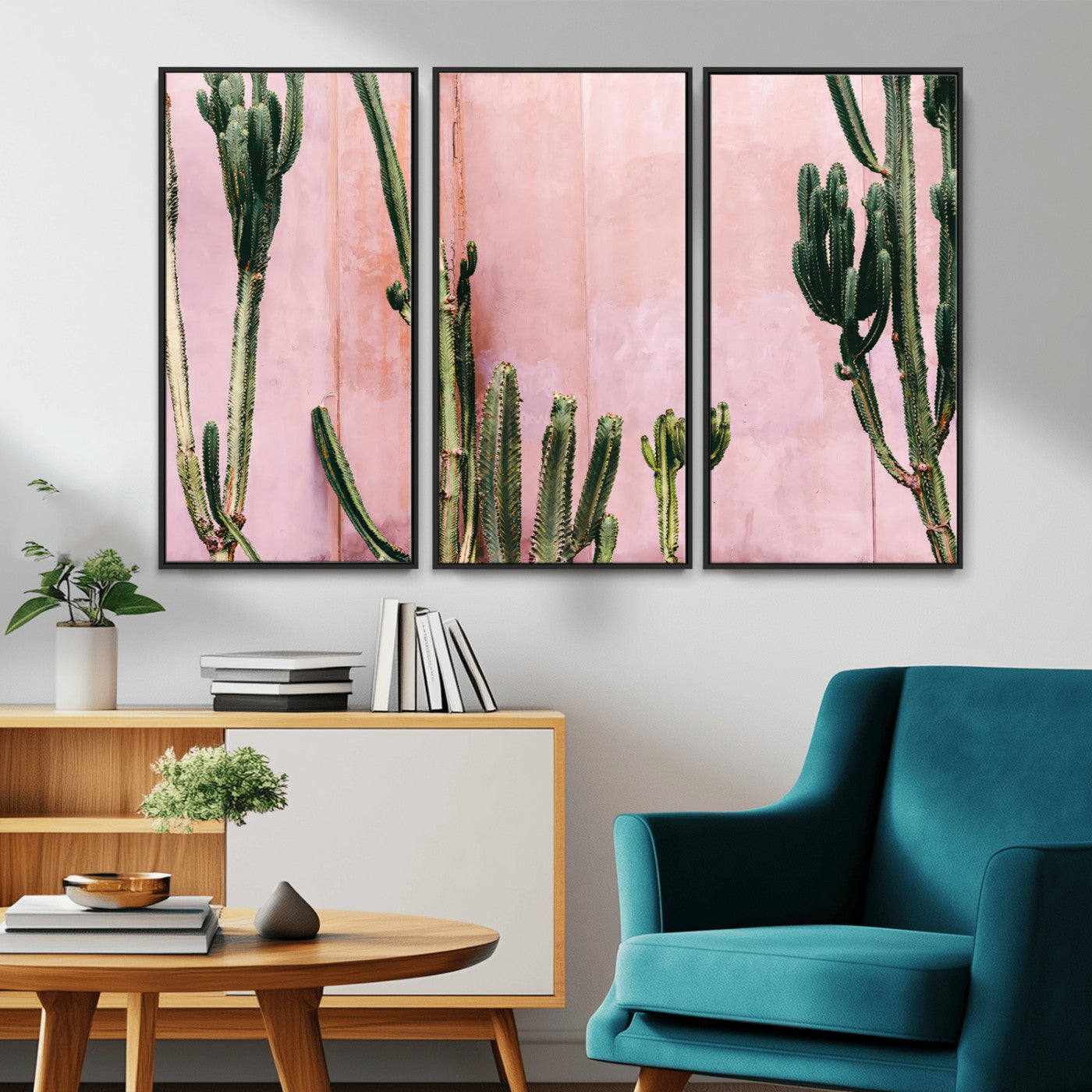 Framed canvas of tall green cacti against a soft pink wall, ideal for modern desert or colorful southwest-inspired home decor.