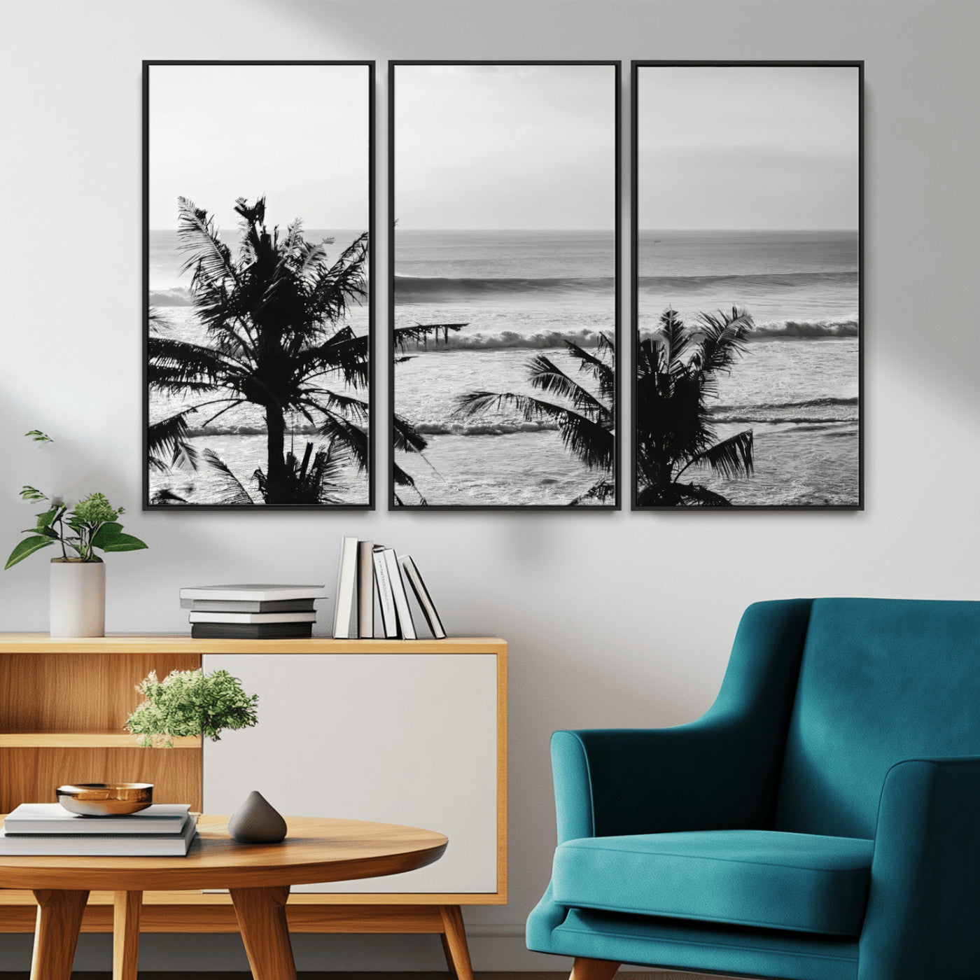 Black and white view of ocean waves crashing on a tropical coastline, framed by silhouetted palm trees under a vast, open sky.