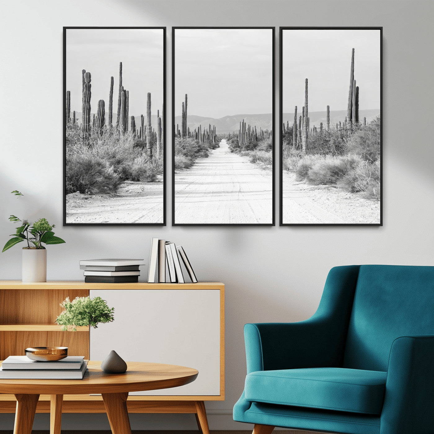 A black and white desert road stretching through a cactus-filled landscape, creating a rugged and timeless southwestern aesthetic with a sense of adventure.