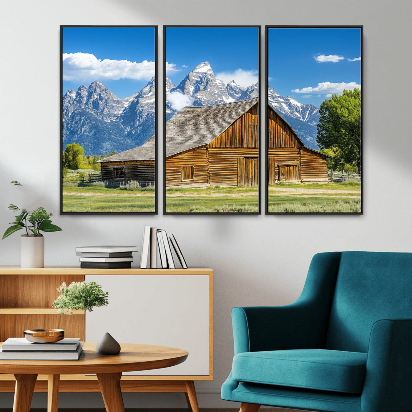 A rustic wooden barn sits in front of towering mountain peaks under a clear blue sky, perfect for farmhouse or cabin style interiors.