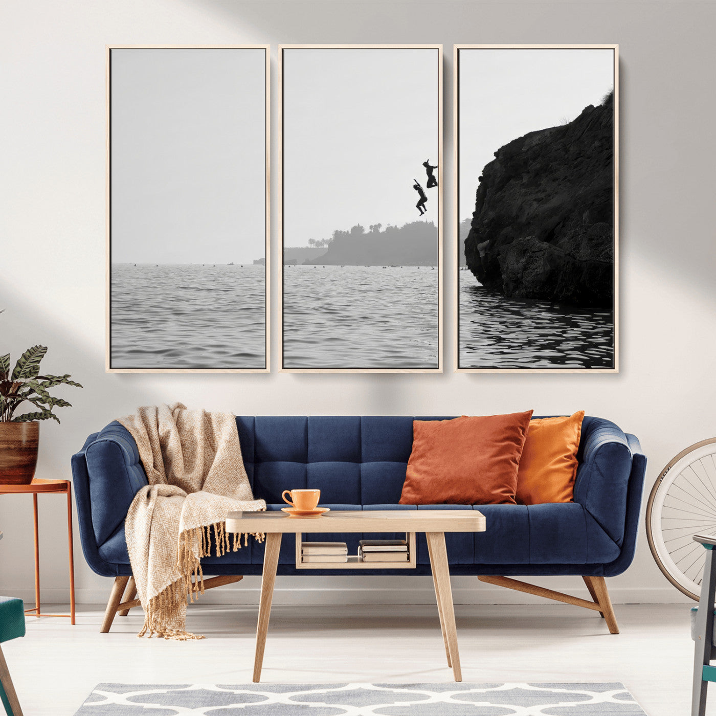 Black and white canvas of two figures cliff jumping into the sea, captured with moody tones, ideal for modern coastal or adventure-themed home decor. 2/2