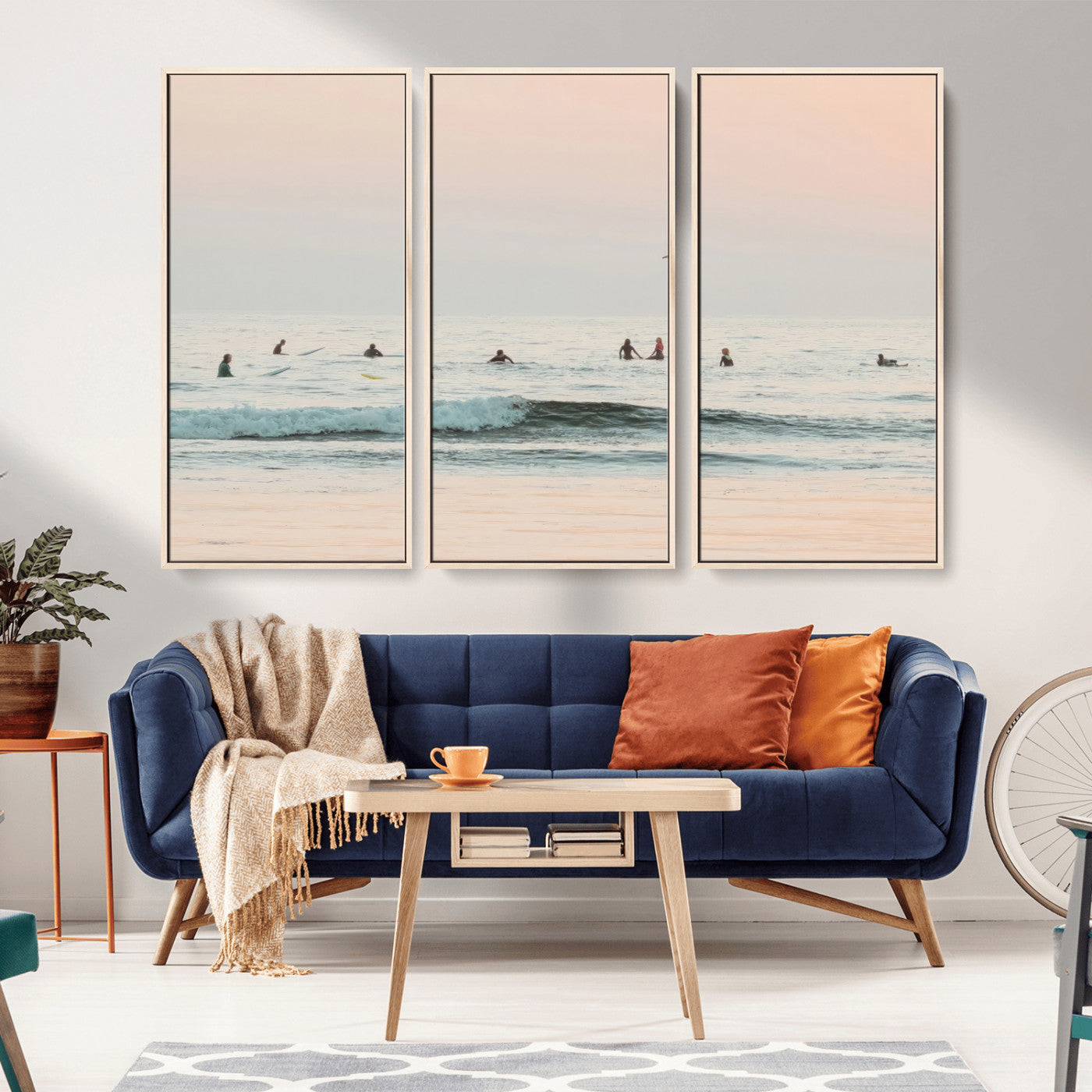 Dreamy photo of surfers waiting on soft pastel waves under a pink sunset sky, ideal for soft coastal minimalist or serene ocean-themed home decor.
