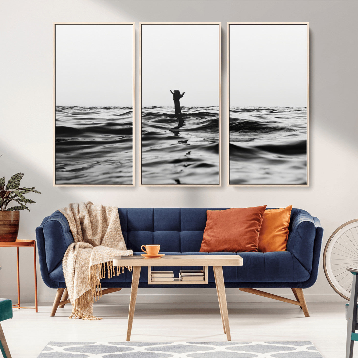 Black and white ocean with a hand making a surfer sign among dark waves, creating a dramatic and minimalist seascape with bold contrast.
