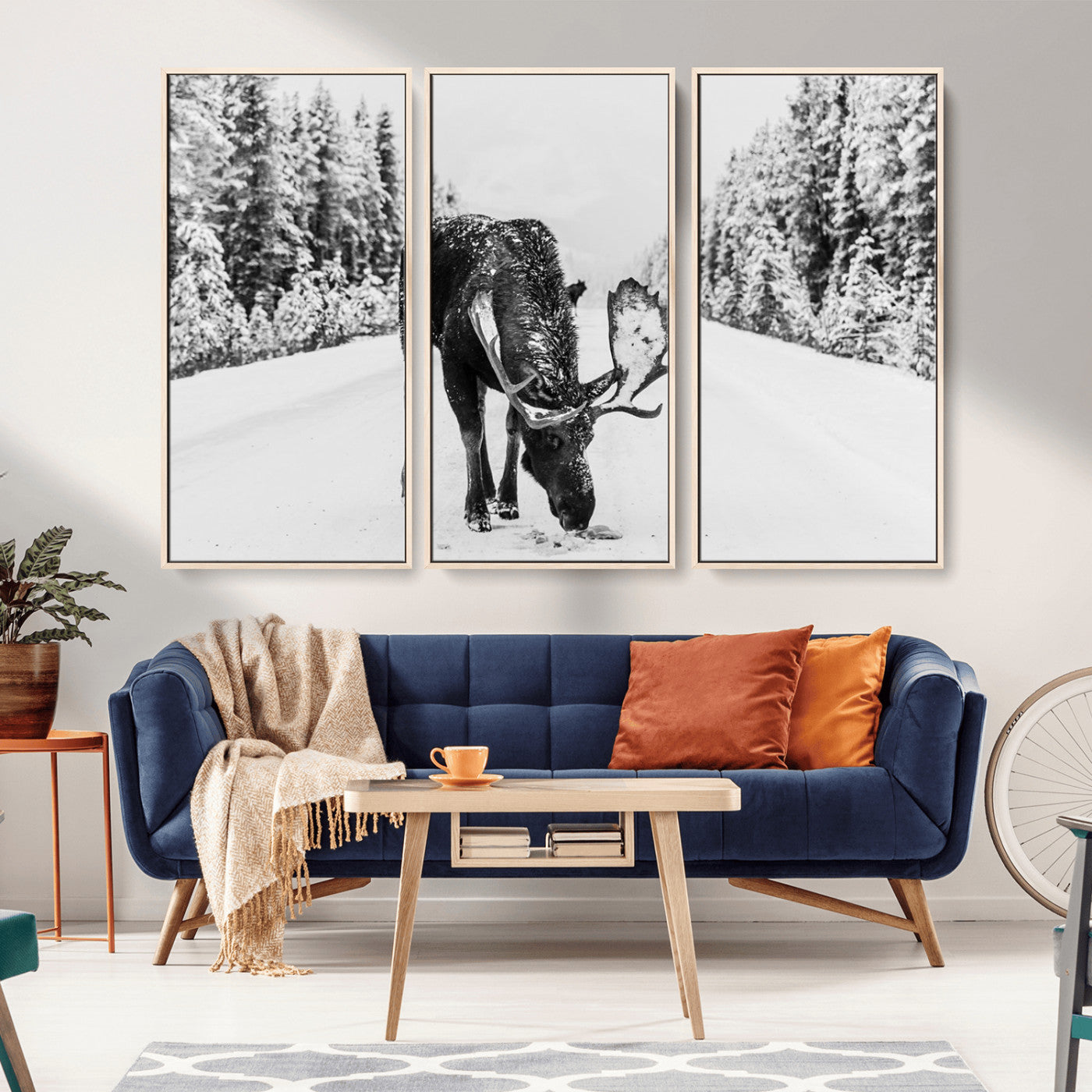 A majestic moose grazing in the snow-covered wilderness, surrounded by snow-covered trees, creating a peaceful winter scene.