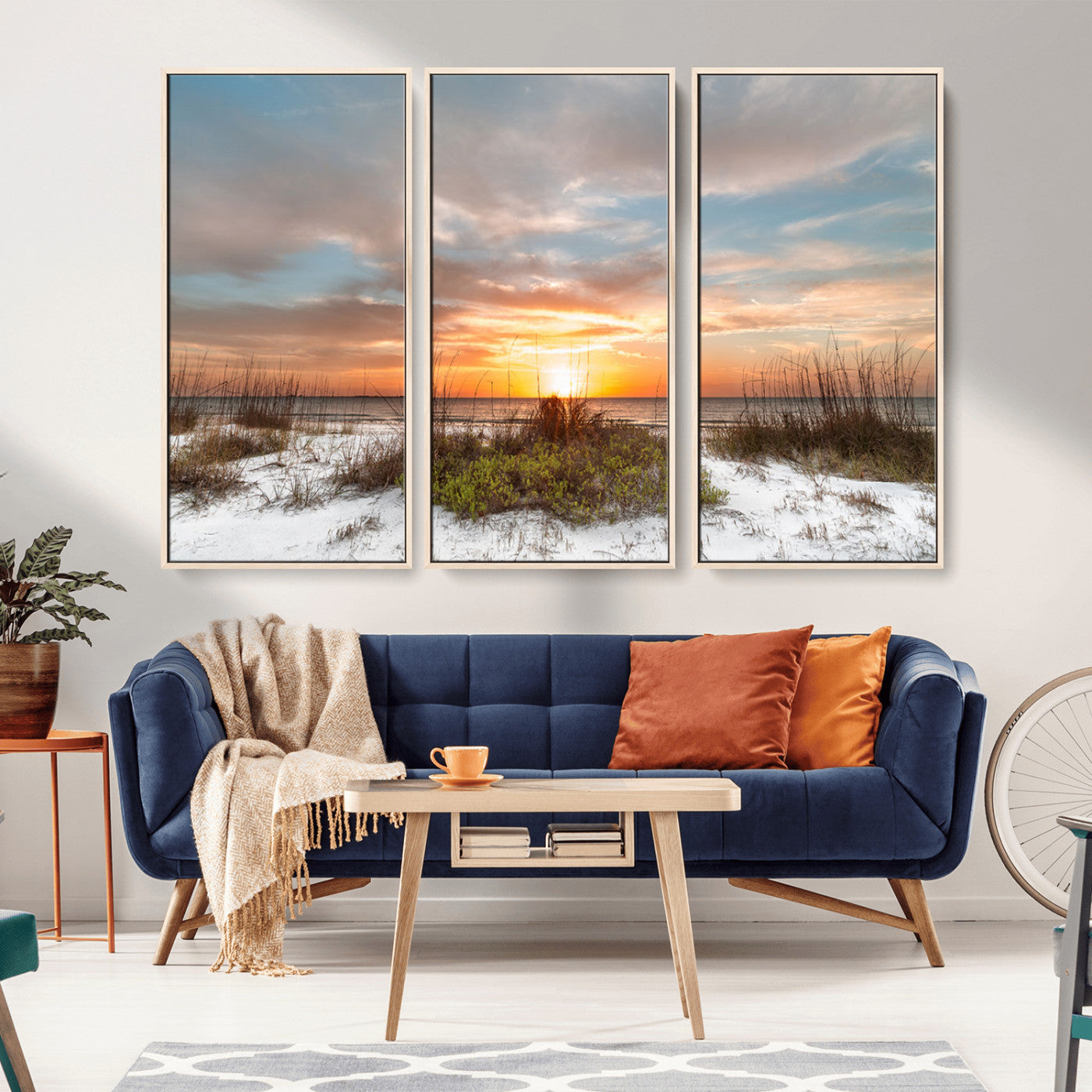 A tranquil beach scene featuring golden sunset hues over the water, with grasses in the foreground and a peaceful, serene atmosphere.