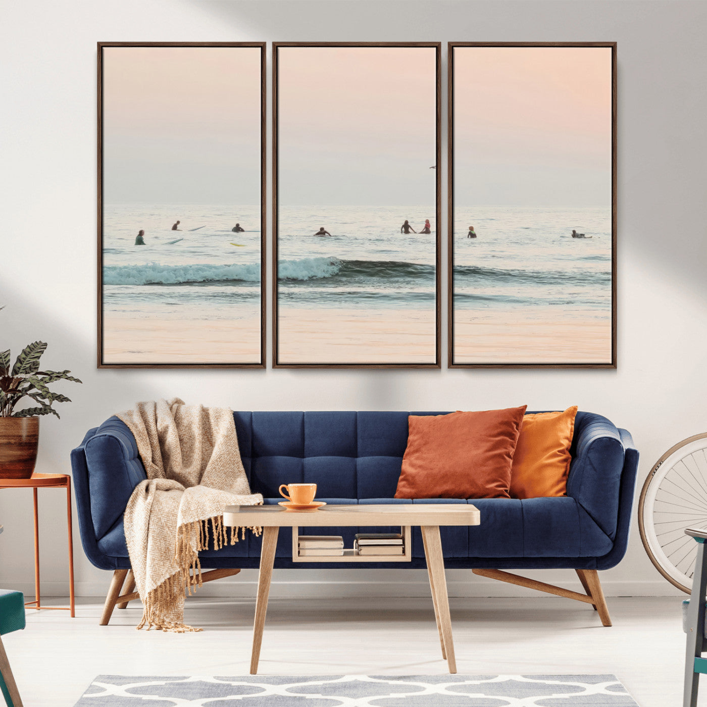 Dreamy photo of surfers waiting on soft pastel waves under a pink sunset sky, ideal for soft coastal minimalist or serene ocean-themed home decor.