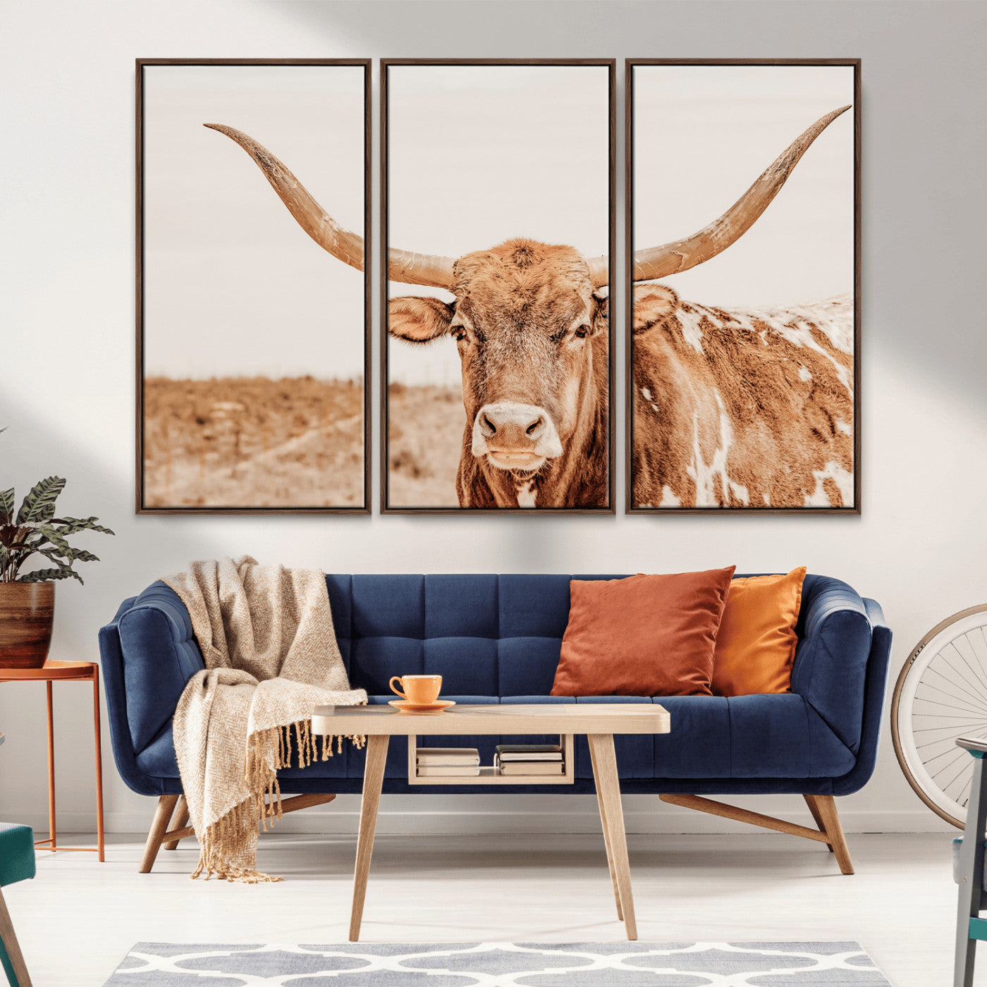 A longhorn bull standing proudly in a sunlit desert field with warm neutral tones, ideal for rustic western or farmhouse interiors.