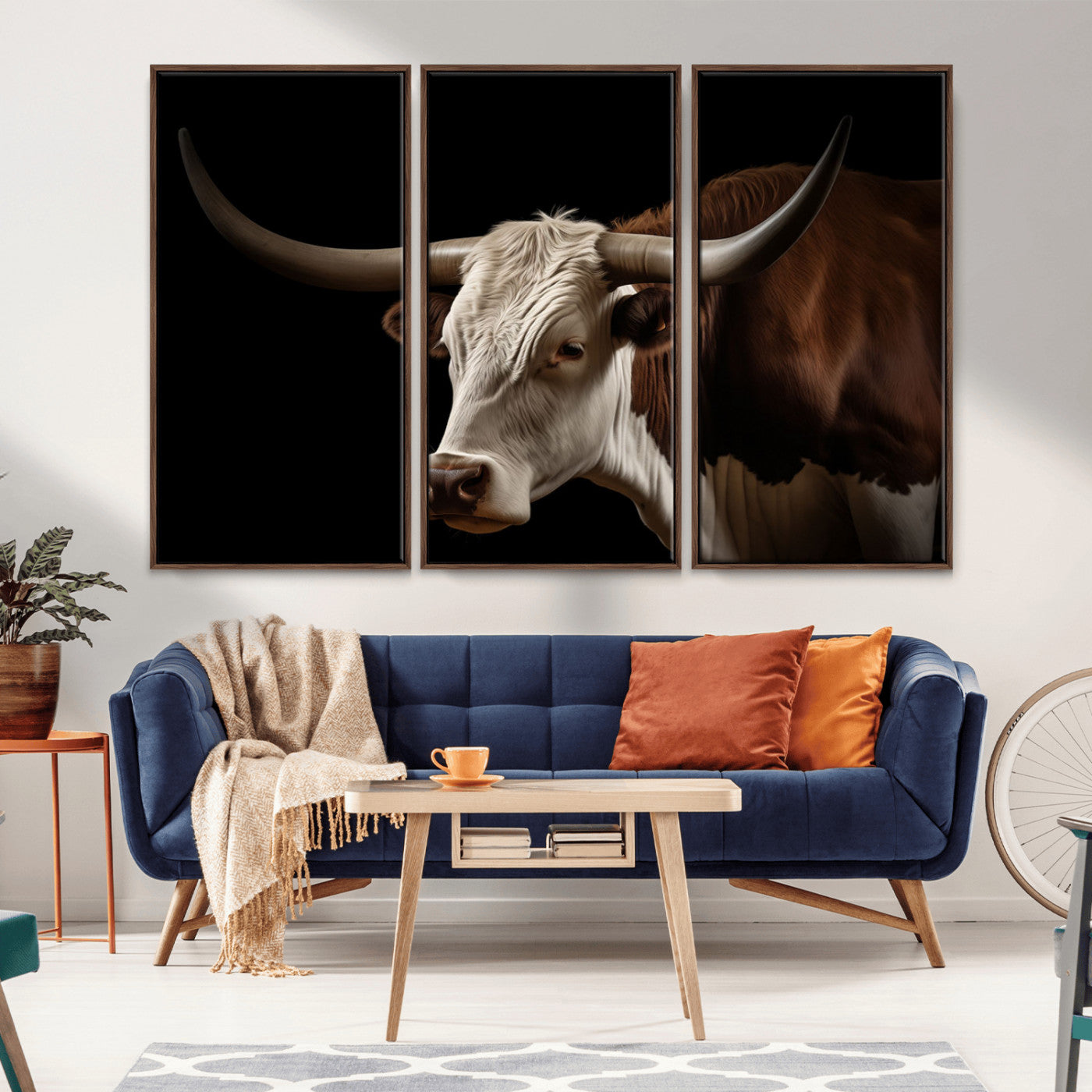 "Close-up of a brown and white longhorn cow with prominent curved horns against a black background."