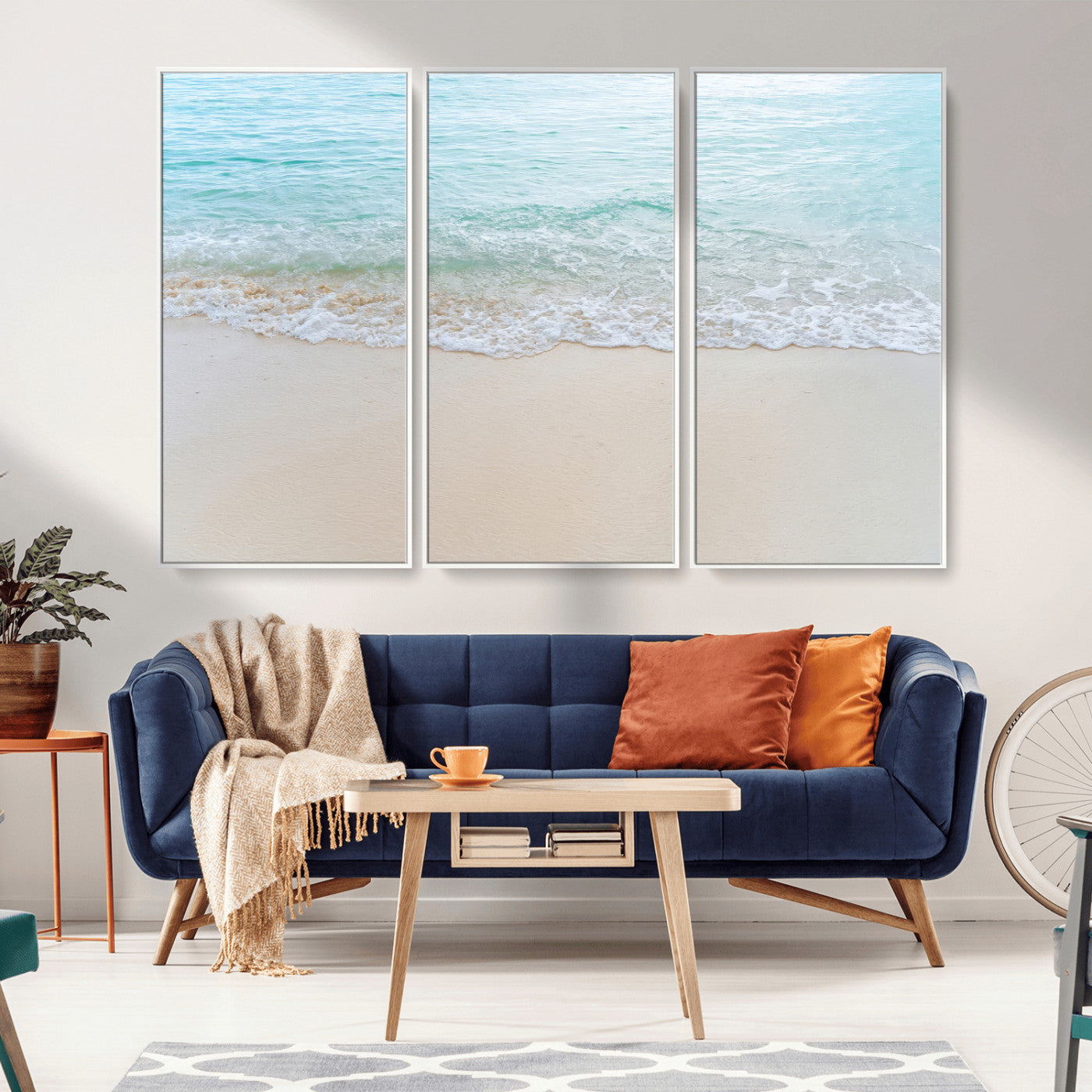 Soft shoreline with gentle aqua waves on smooth sand, ideal for minimalist coastal or pastel ocean-inspired home wall decor.