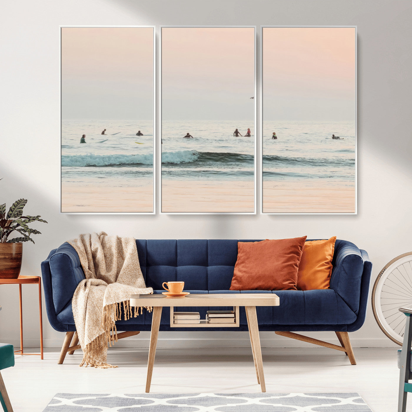Dreamy photo of surfers waiting on soft pastel waves under a pink sunset sky, ideal for soft coastal minimalist or serene ocean-themed home decor.