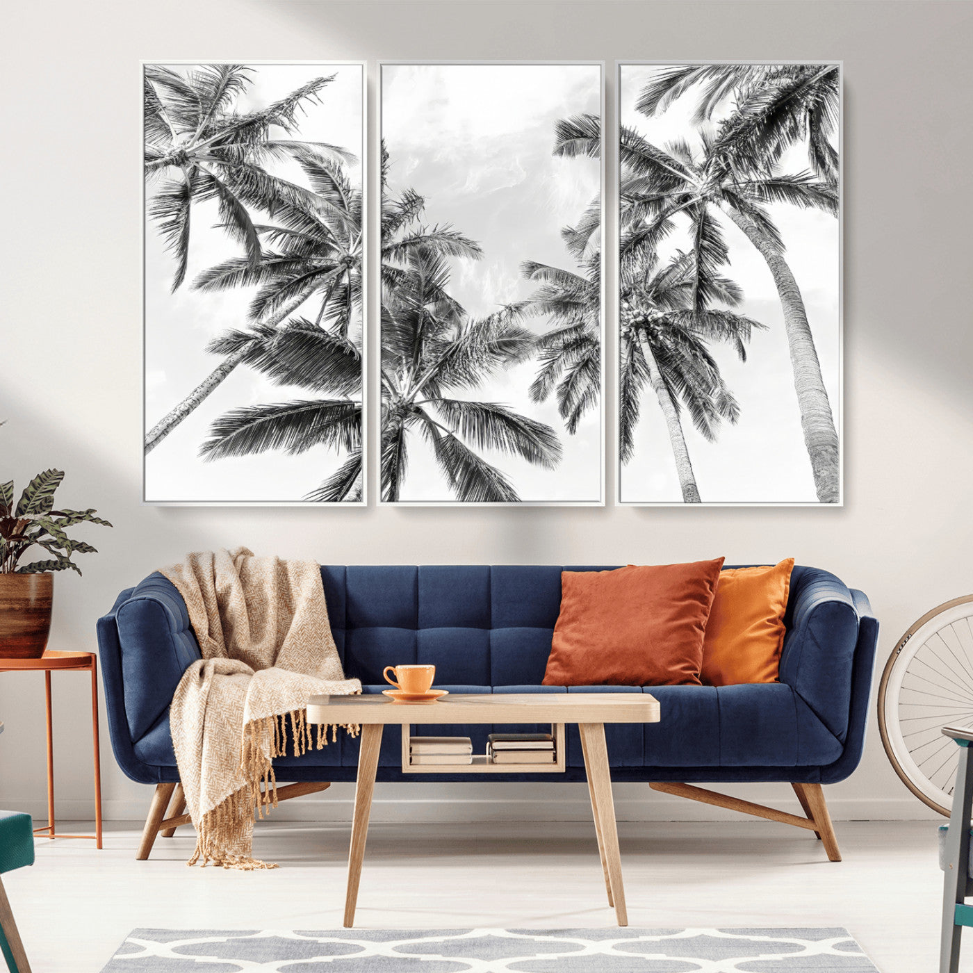 Black and white tropical palm trees viewed from below, swaying gently against a bright sky, creating a serene and elegant coastal atmosphere.
