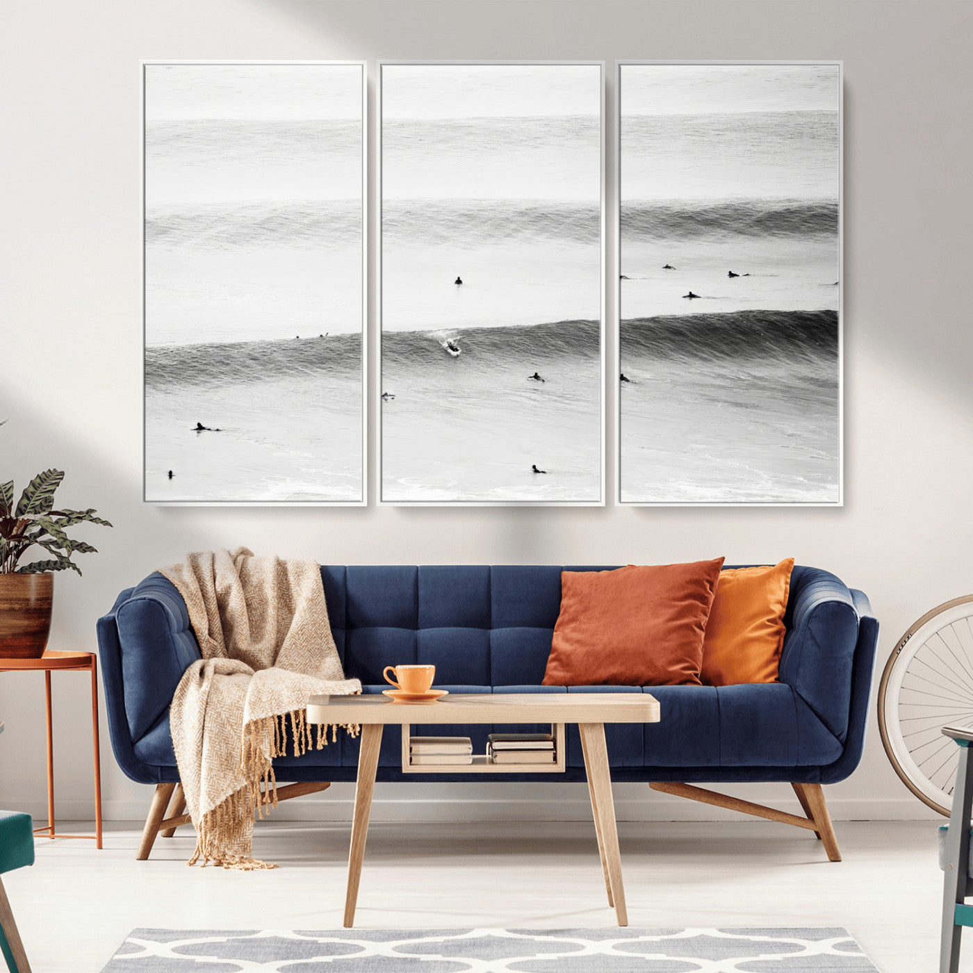 A monochrome photograph of swimmers gliding through gentle ocean waves, evoking a sense of calm and movement.