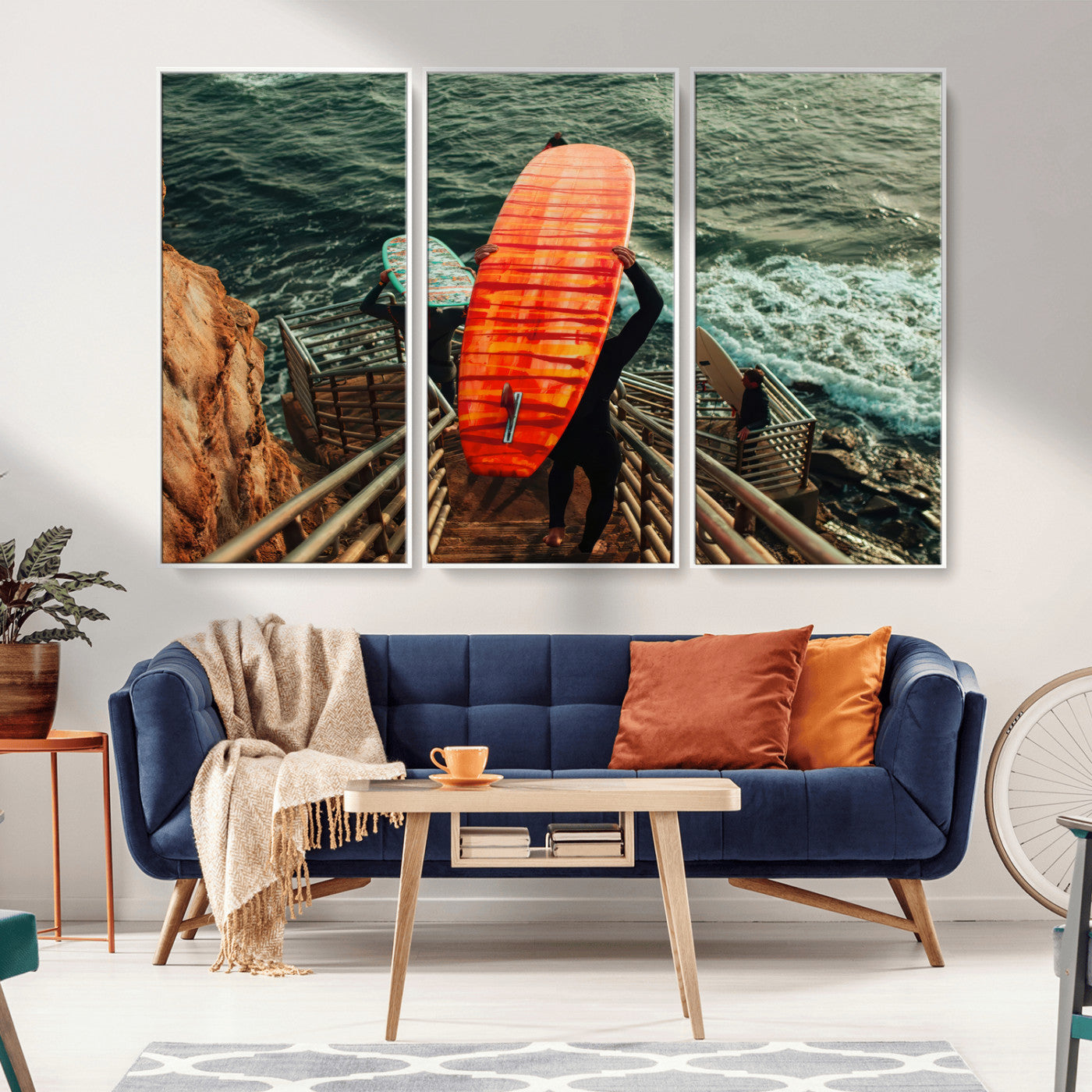 A surfer carrying a bold orange surfboard down a rugged staircase toward the ocean, bathed in golden hour light, capturing the energy of coastal adventure.