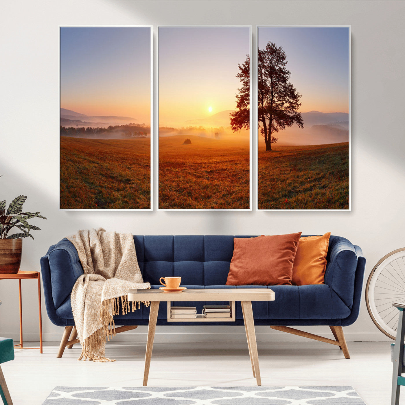 A tranquil landscape at sunrise with a mist-covered field and a lone tree, creating a peaceful and natural atmosphere.