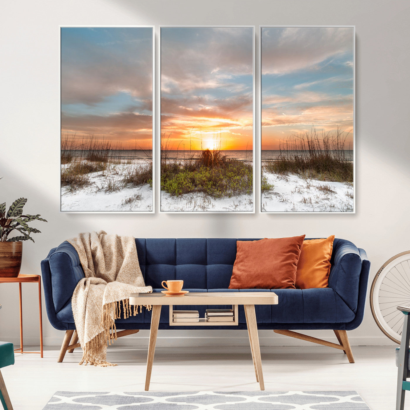A tranquil beach scene featuring golden sunset hues over the water, with grasses in the foreground and a peaceful, serene atmosphere.