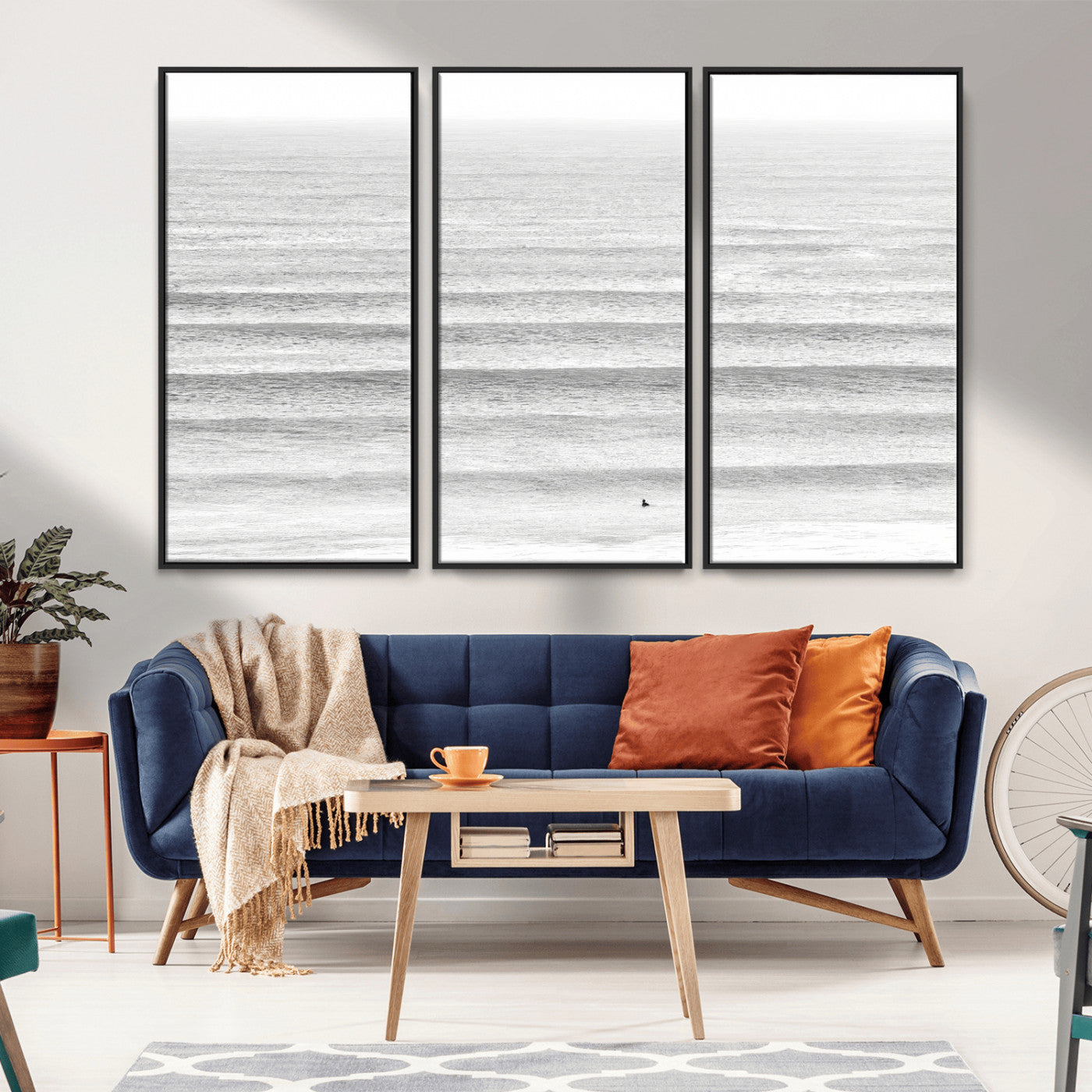 Monochrome photo of a lone surfer in calm layered waves, perfect for minimalist coastal or moody ocean-inspired wall decoration.