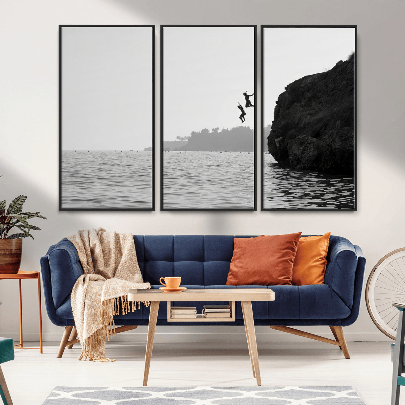 Black and white canvas of two figures cliff jumping into the sea, captured with moody tones, ideal for modern coastal or adventure-themed home decor. 2/2
