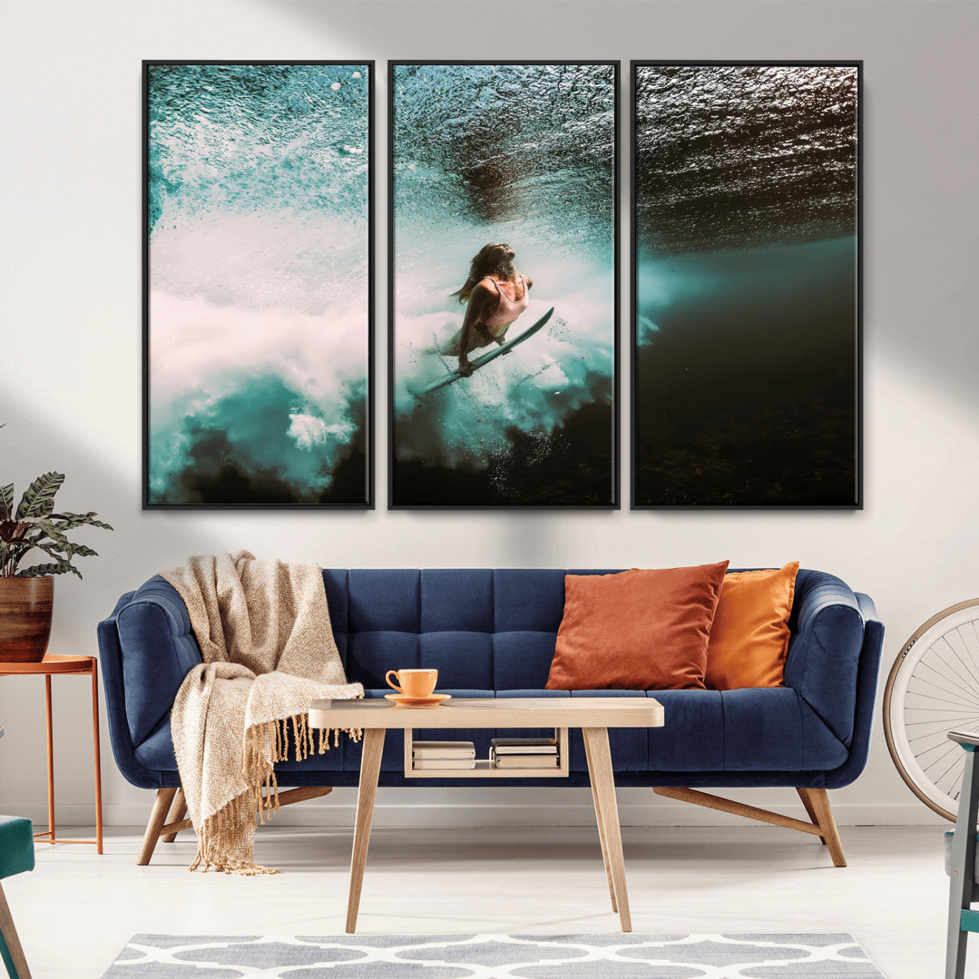 Vibrant underwater photo of a female surfer diving through turquoise waves, perfect for coastal boho or surf-inspired home decor.