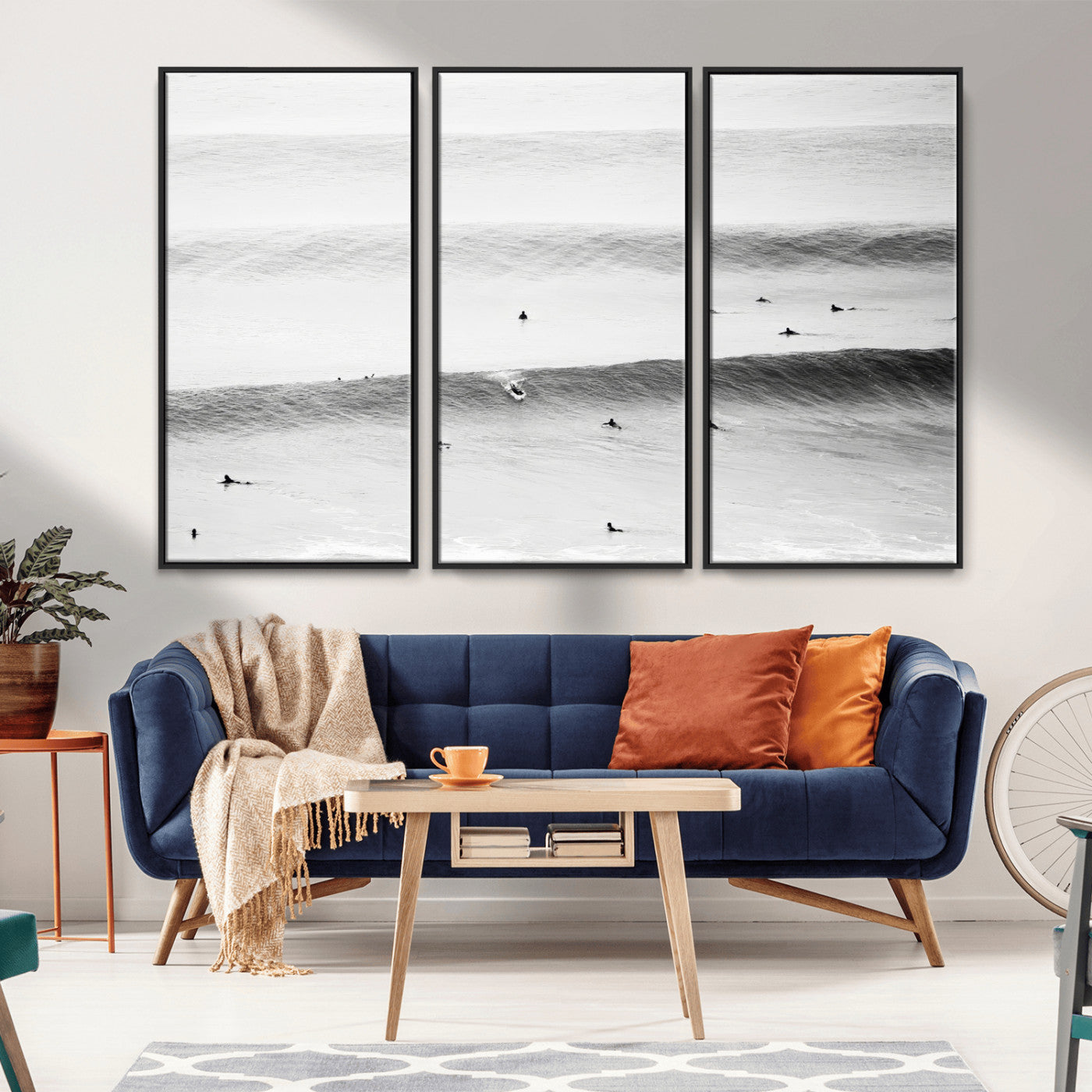 A monochrome photograph of swimmers gliding through gentle ocean waves, evoking a sense of calm and movement.