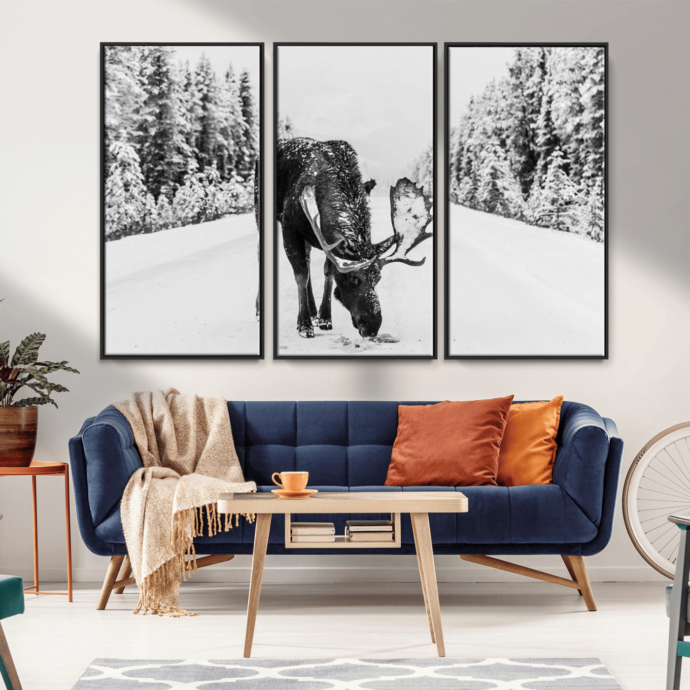 A majestic moose grazing in the snow-covered wilderness, surrounded by snow-covered trees, creating a peaceful winter scene.