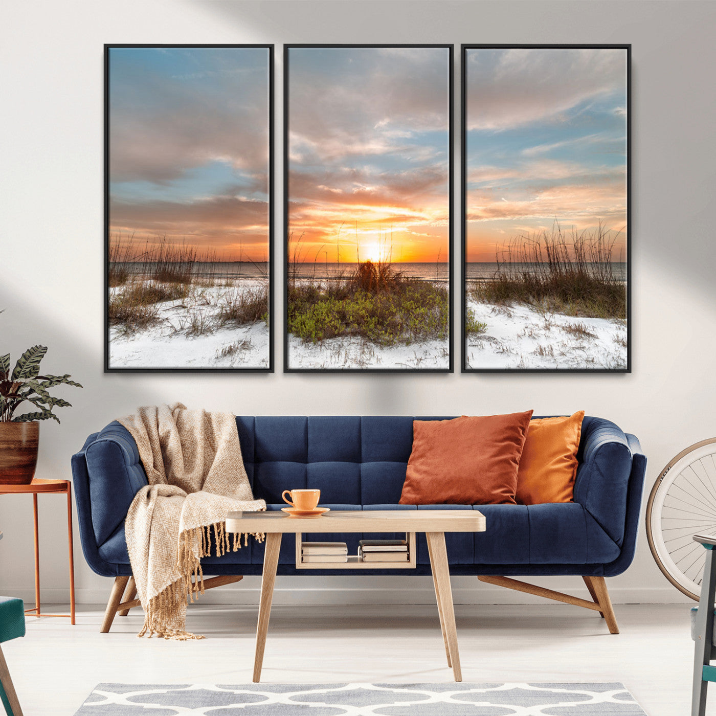 A tranquil beach scene featuring golden sunset hues over the water, with grasses in the foreground and a peaceful, serene atmosphere.
