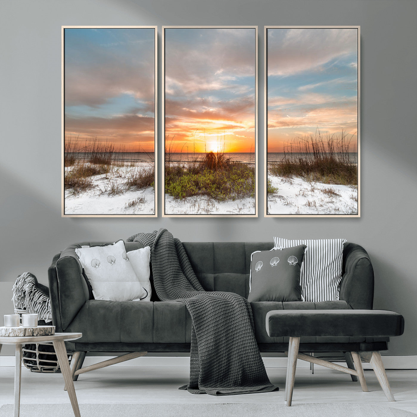 A tranquil beach scene featuring golden sunset hues over the water, with grasses in the foreground and a peaceful, serene atmosphere.