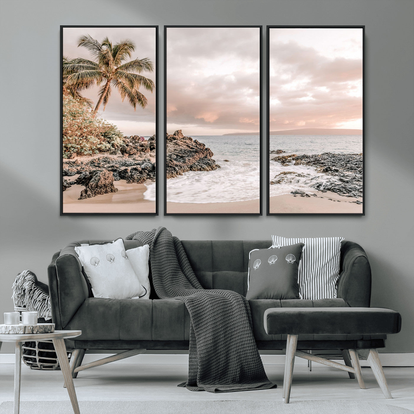 A peaceful beach scene with a palm tree and rocks, soft waves washing onto the shore under a soft pastel sky at sunset.