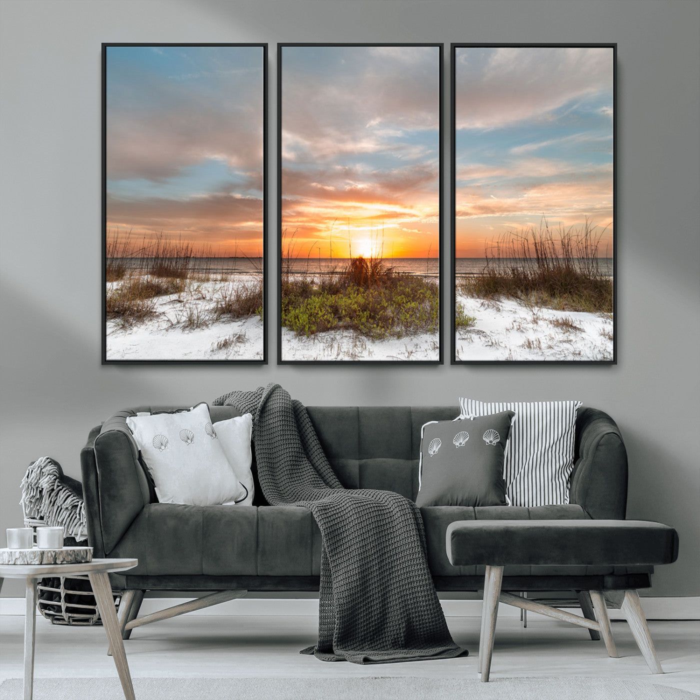 A tranquil beach scene featuring golden sunset hues over the water, with grasses in the foreground and a peaceful, serene atmosphere.