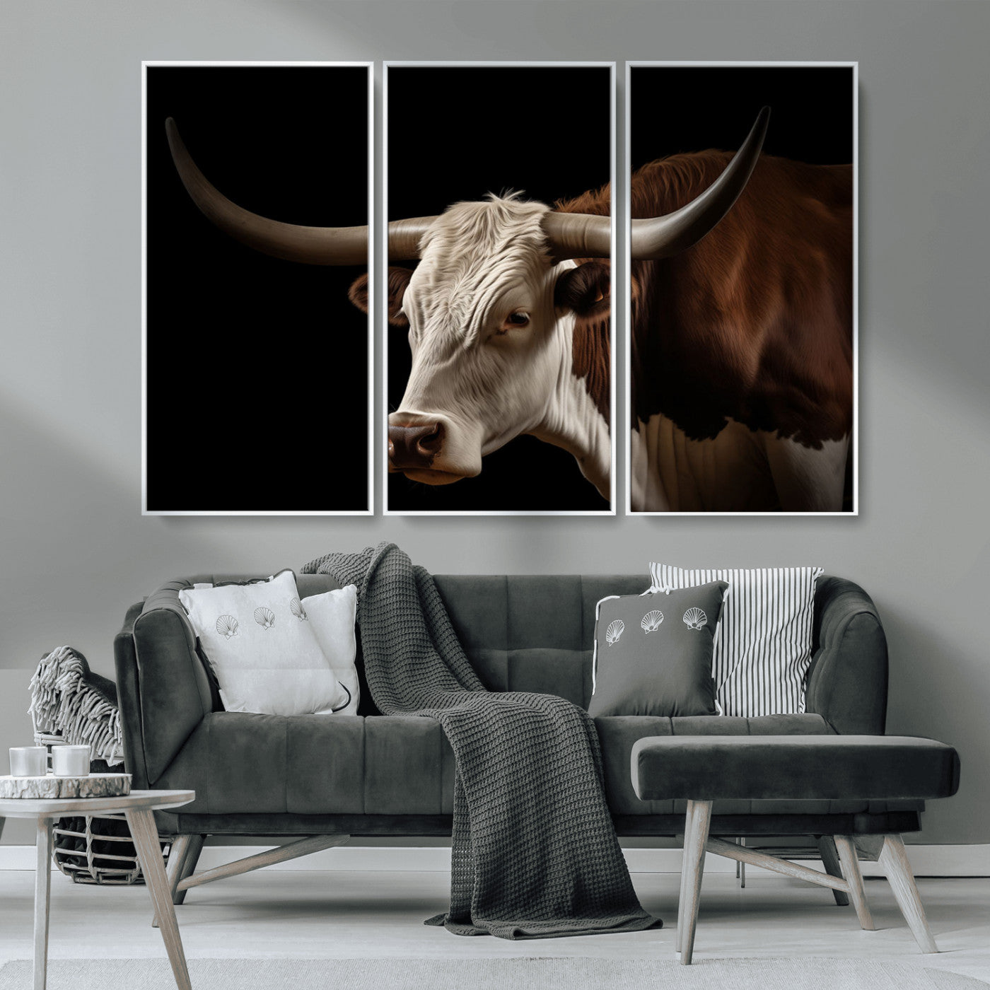 "Close-up of a brown and white longhorn cow with prominent curved horns against a black background."