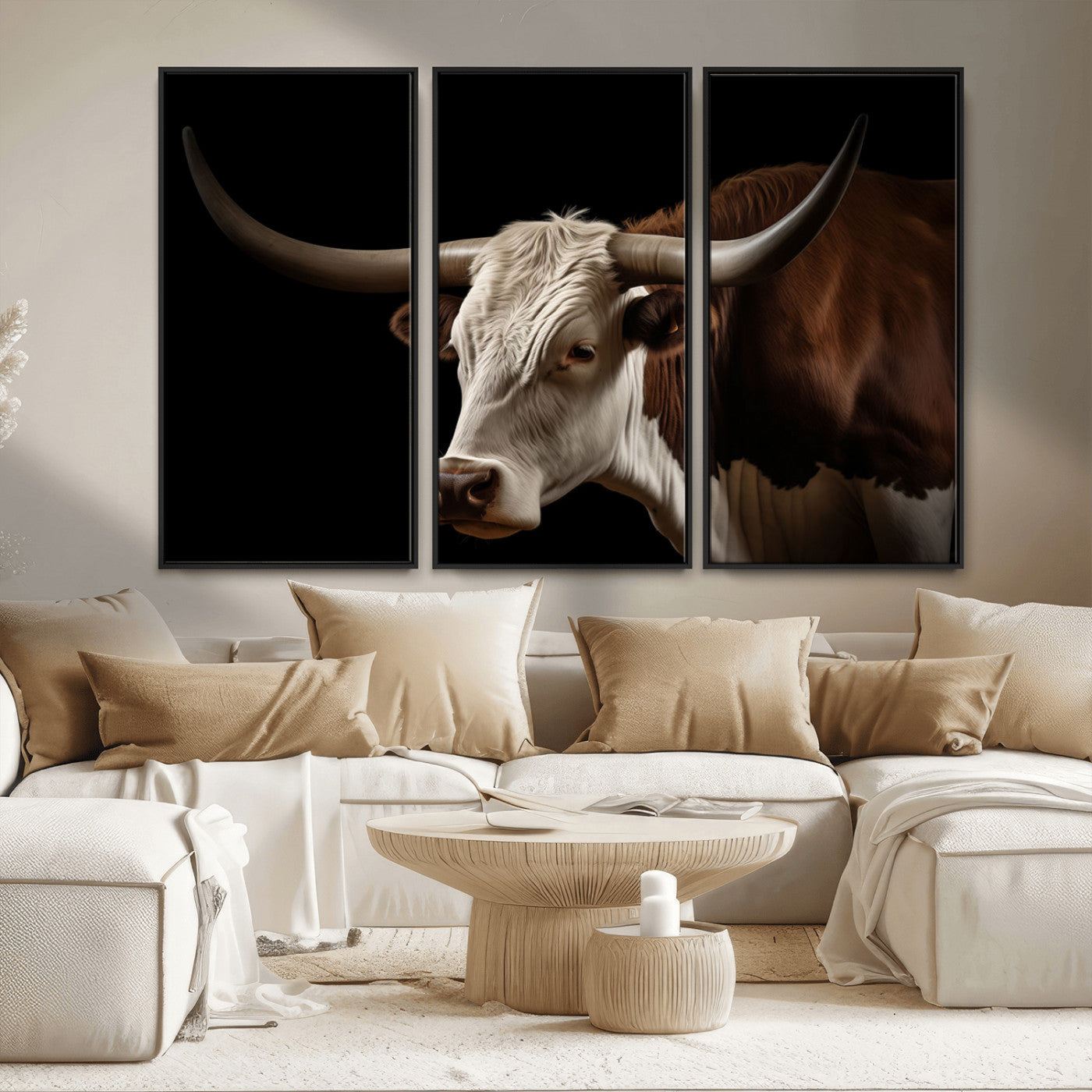 "Close-up of a brown and white longhorn cow with prominent curved horns against a black background."