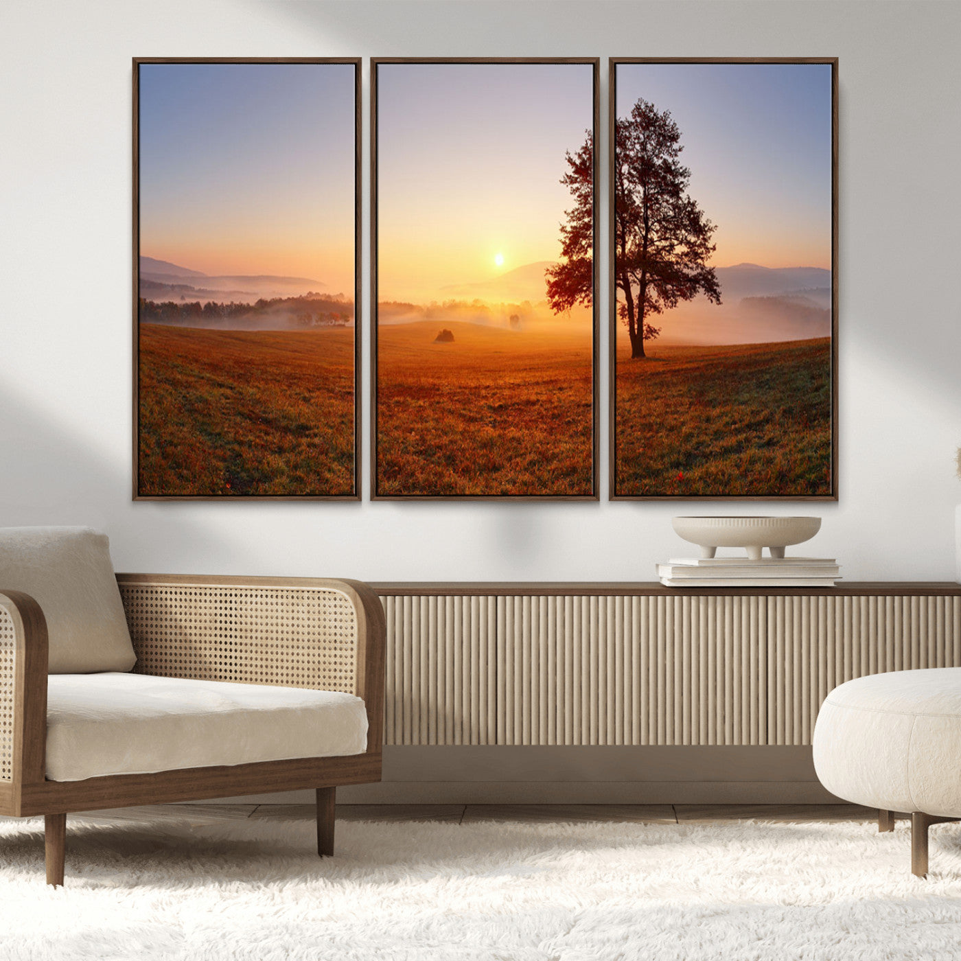 A tranquil landscape at sunrise with a mist-covered field and a lone tree, creating a peaceful and natural atmosphere.