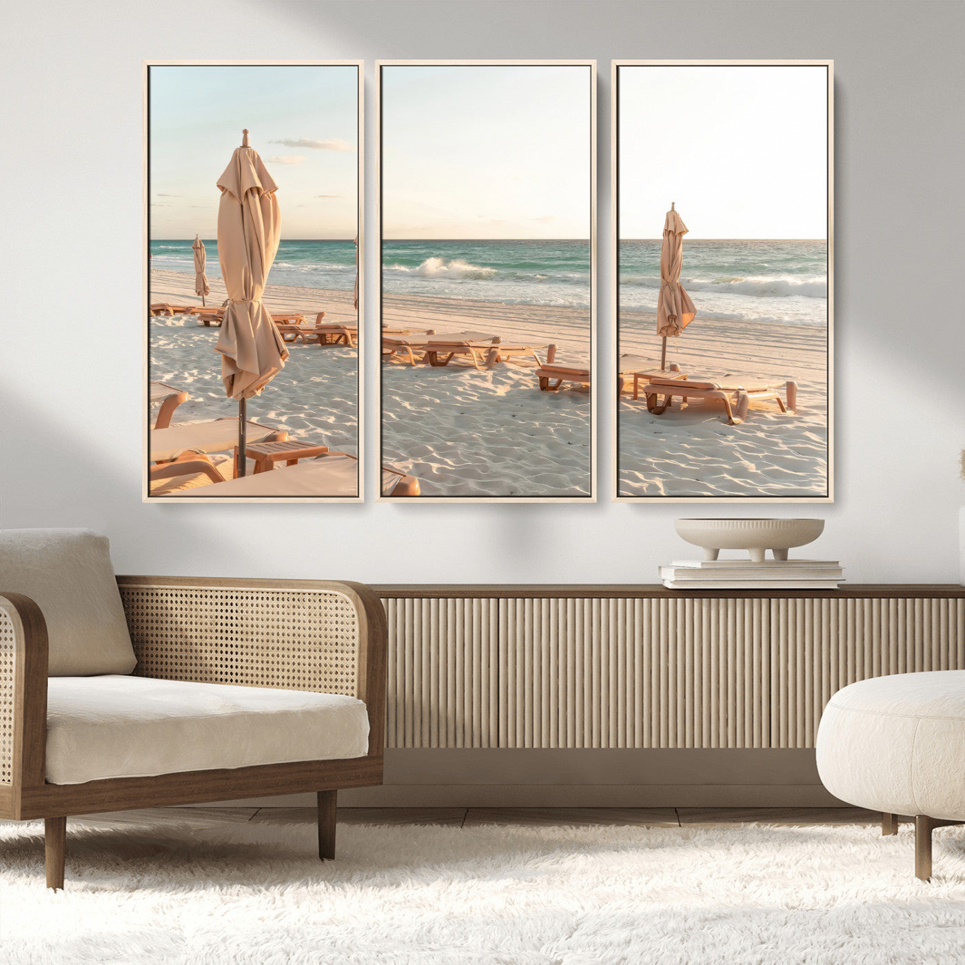 Minimalist photo of empty beach loungers and umbrellas on soft sand, ideal for calm seaside or pastel coastal-style home decor.