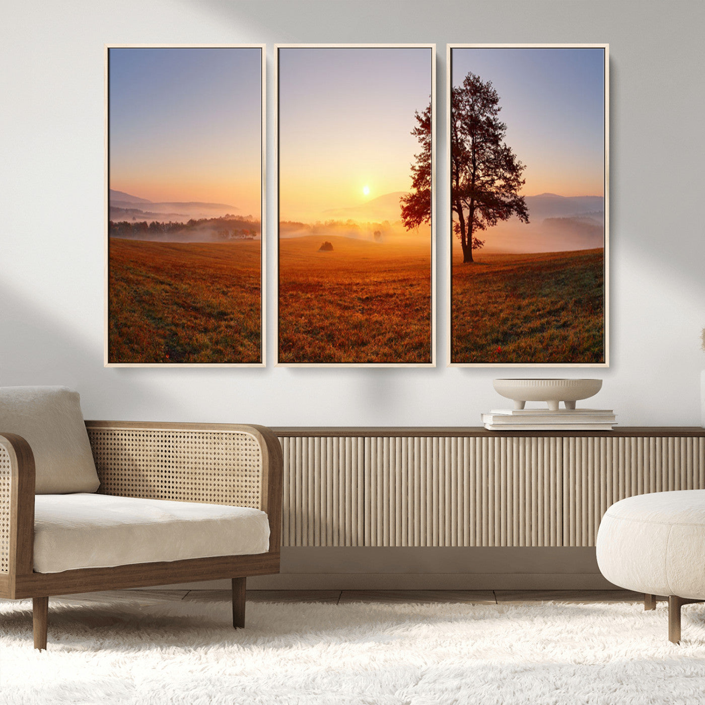 A tranquil landscape at sunrise with a mist-covered field and a lone tree, creating a peaceful and natural atmosphere.