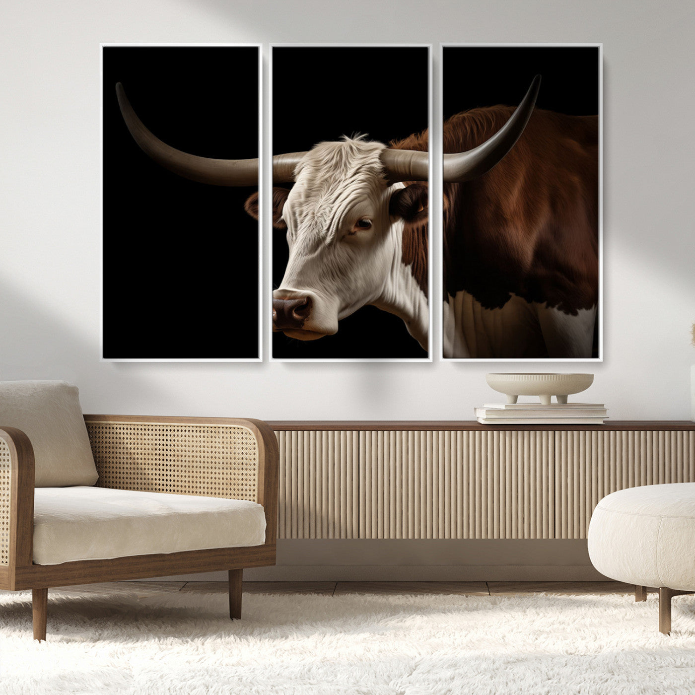 "Close-up of a brown and white longhorn cow with prominent curved horns against a black background."