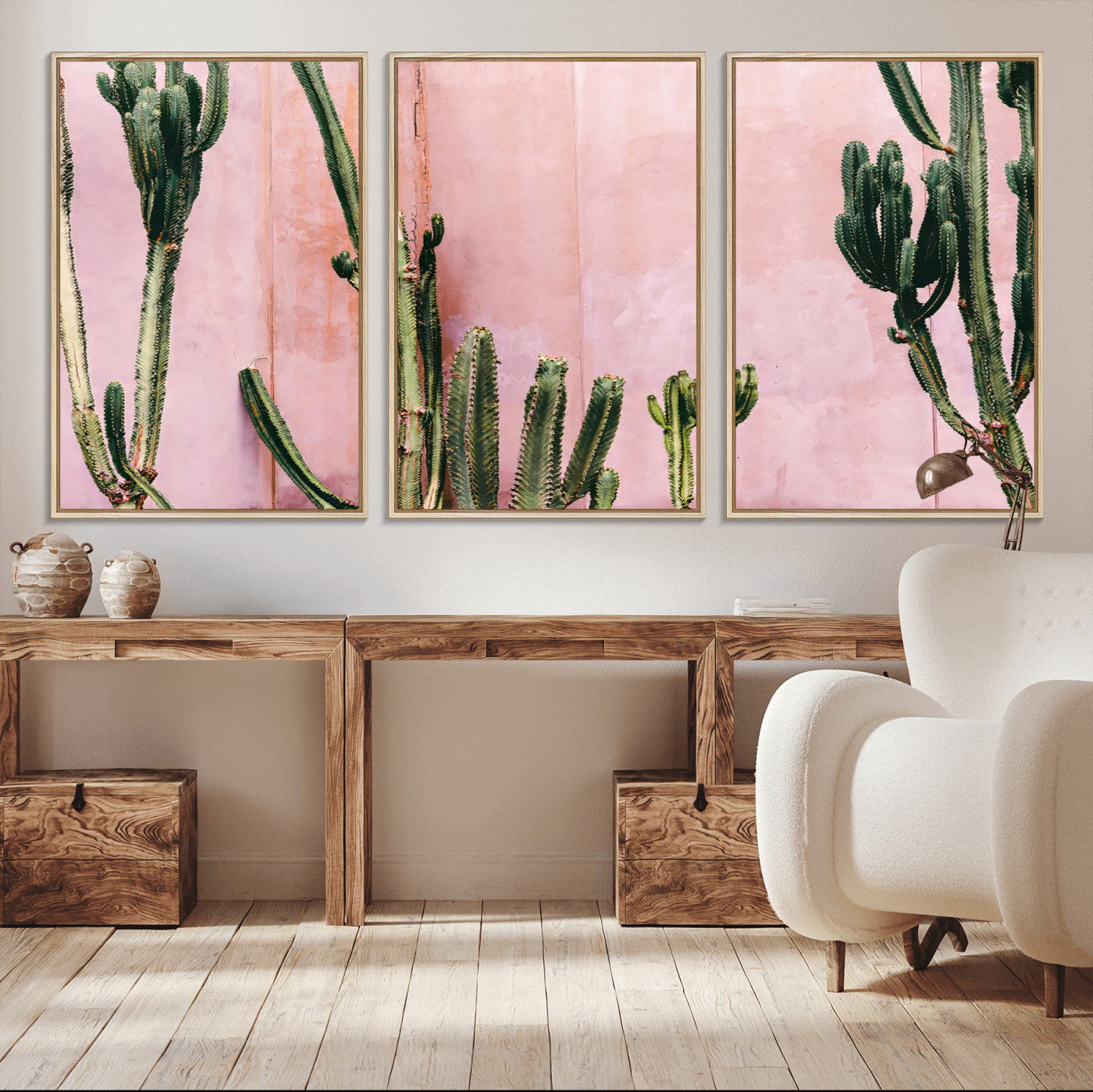 Framed canvas of tall green cacti against a soft pink wall, ideal for modern desert or colorful southwest-inspired home decor.