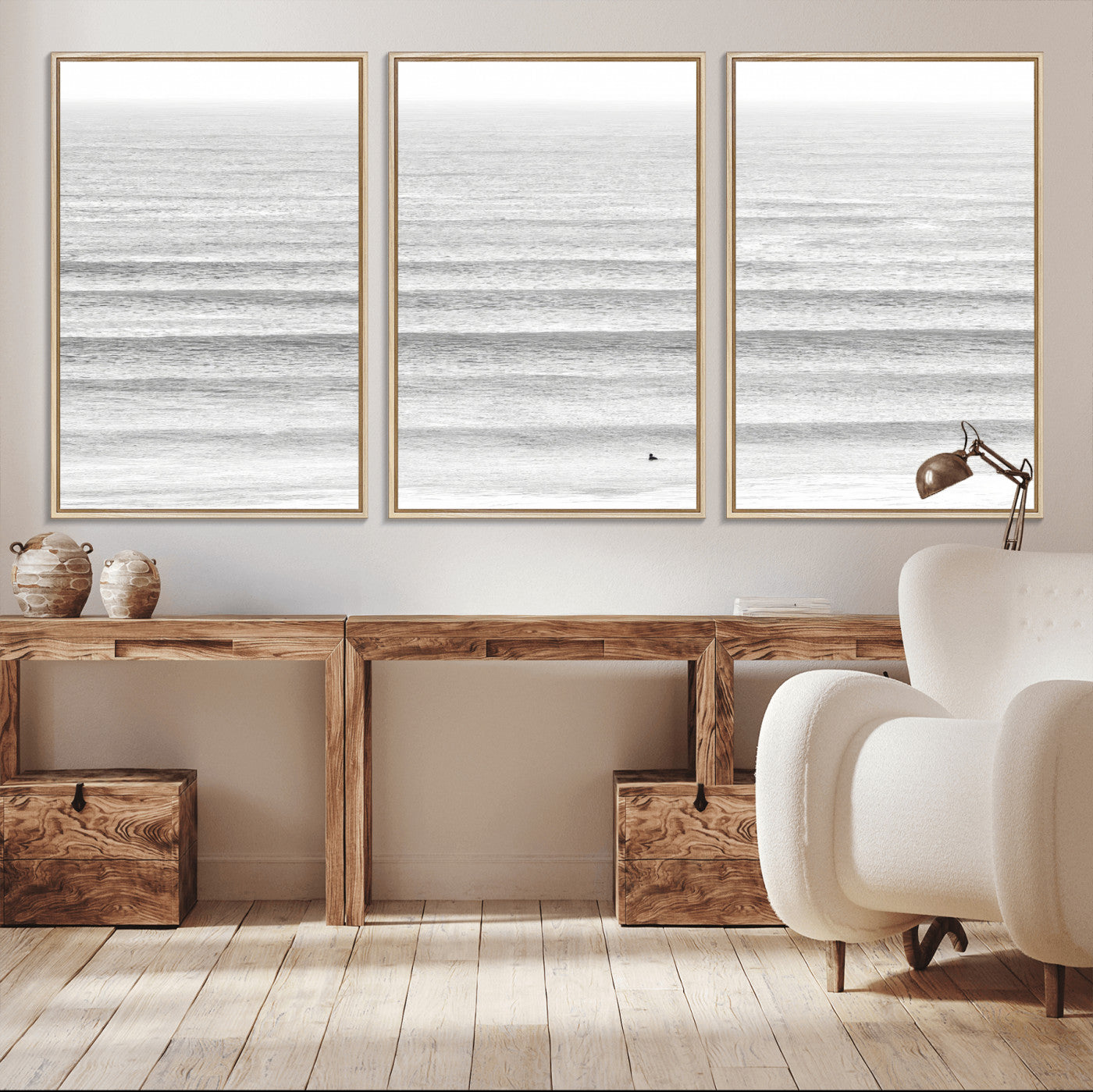 Monochrome photo of a lone surfer in calm layered waves, perfect for minimalist coastal or moody ocean-inspired wall decoration.