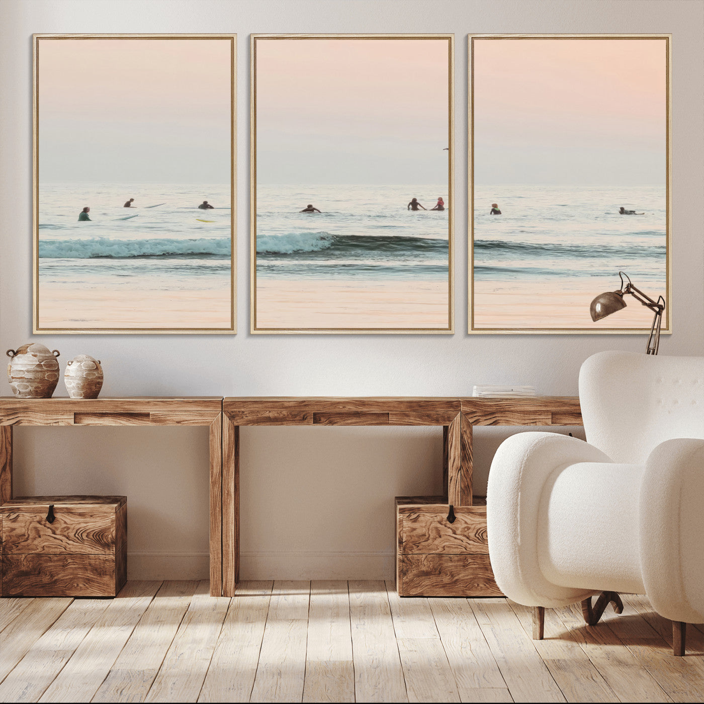 Dreamy photo of surfers waiting on soft pastel waves under a pink sunset sky, ideal for soft coastal minimalist or serene ocean-themed home decor.