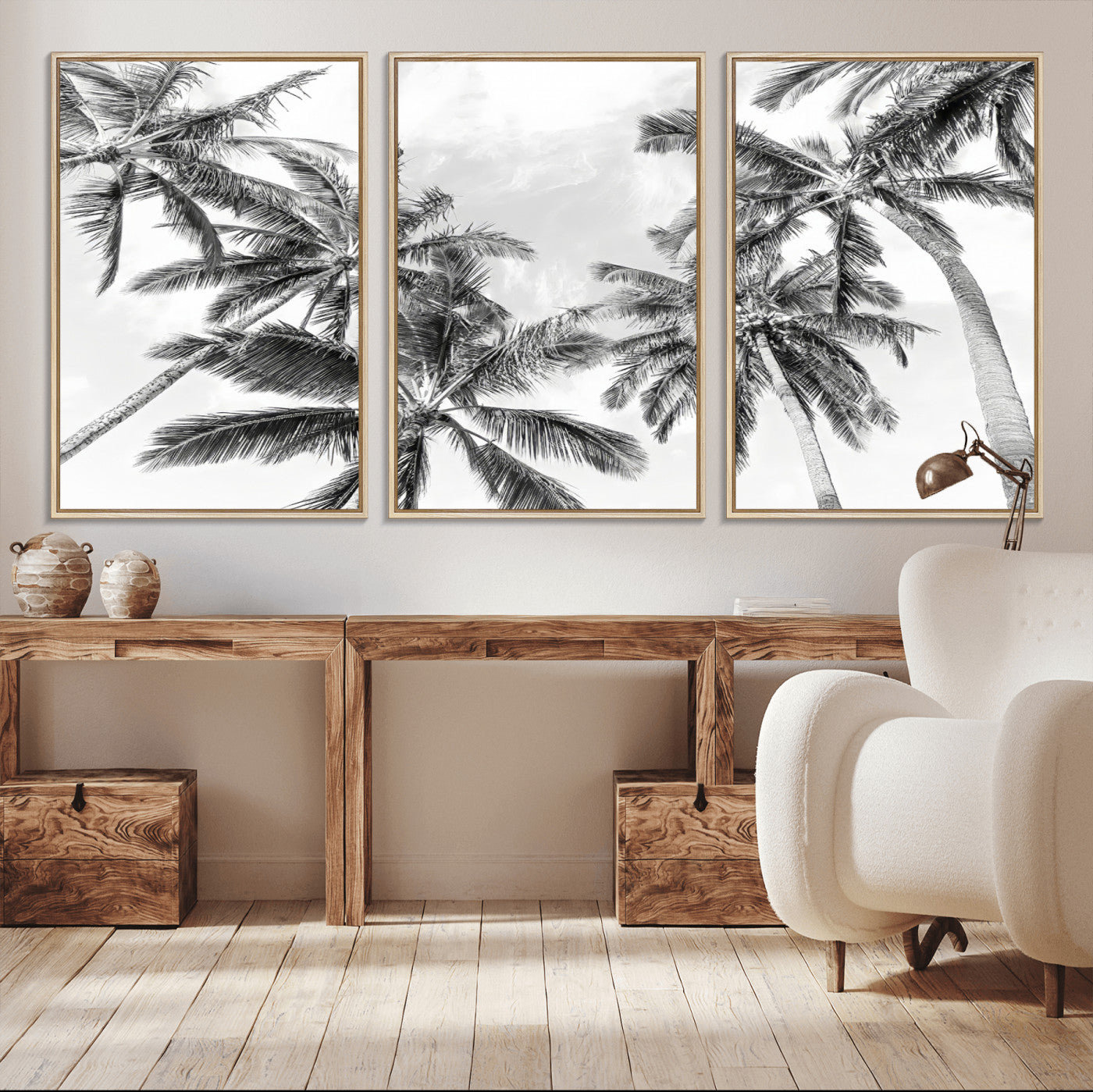 Black and white tropical palm trees viewed from below, swaying gently against a bright sky, creating a serene and elegant coastal atmosphere.