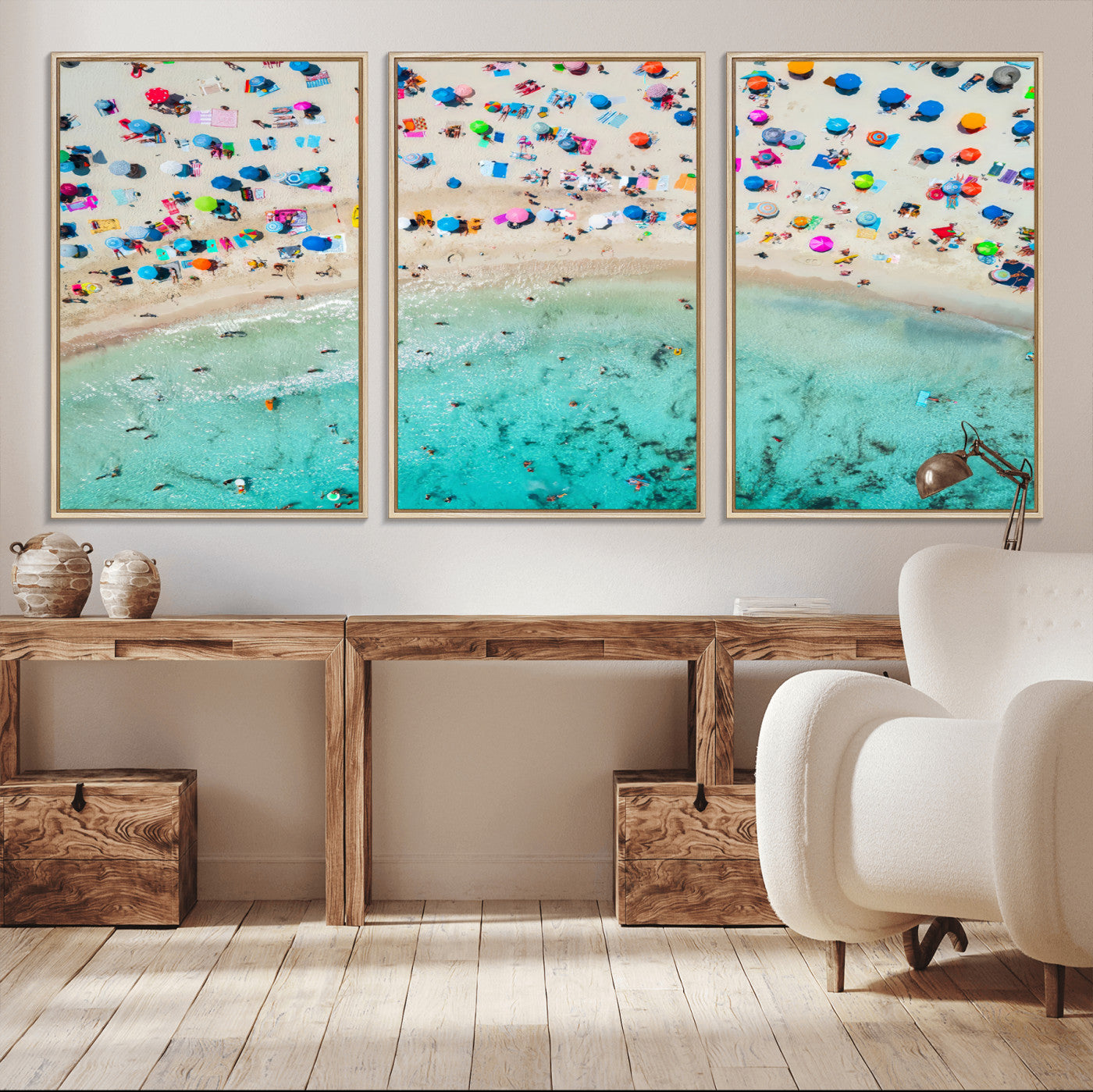 Aerial view of a vibrant beach filled with colorful umbrellas and people enjoying the turquoise ocean, capturing a lively summer vacation scene.