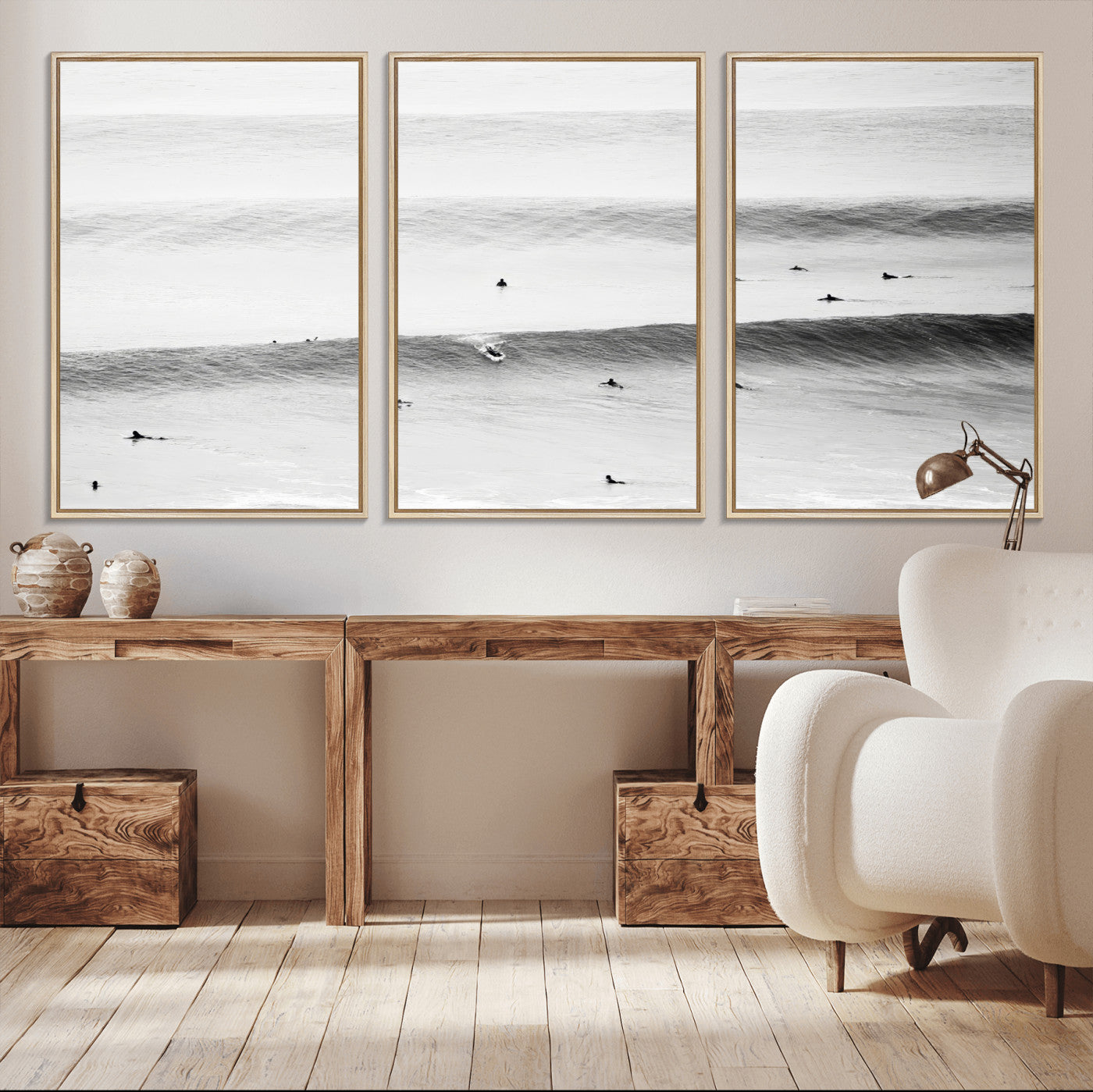 A monochrome photograph of swimmers gliding through gentle ocean waves, evoking a sense of calm and movement.