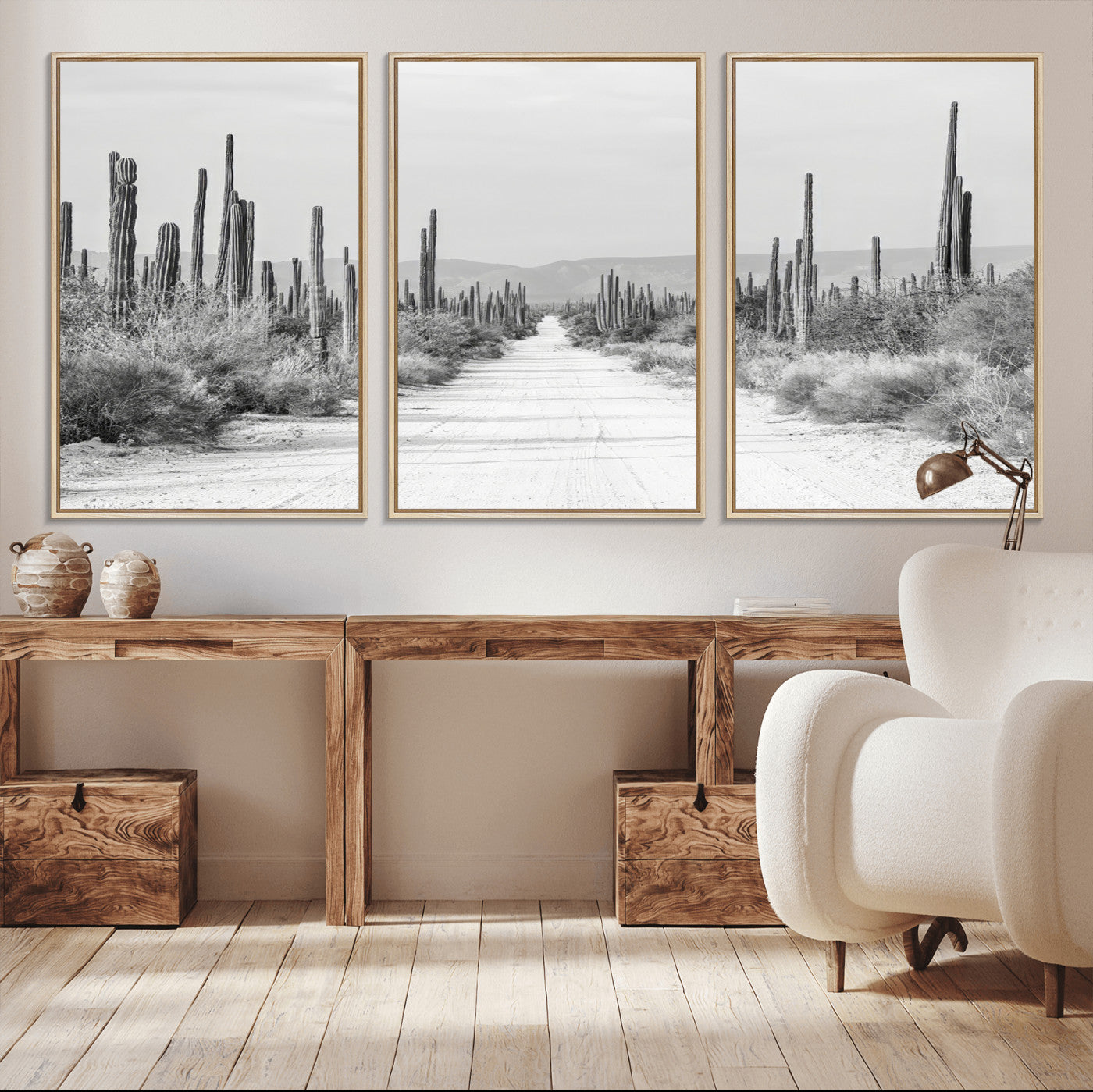 A black and white desert road stretching through a cactus-filled landscape, creating a rugged and timeless southwestern aesthetic with a sense of adventure.