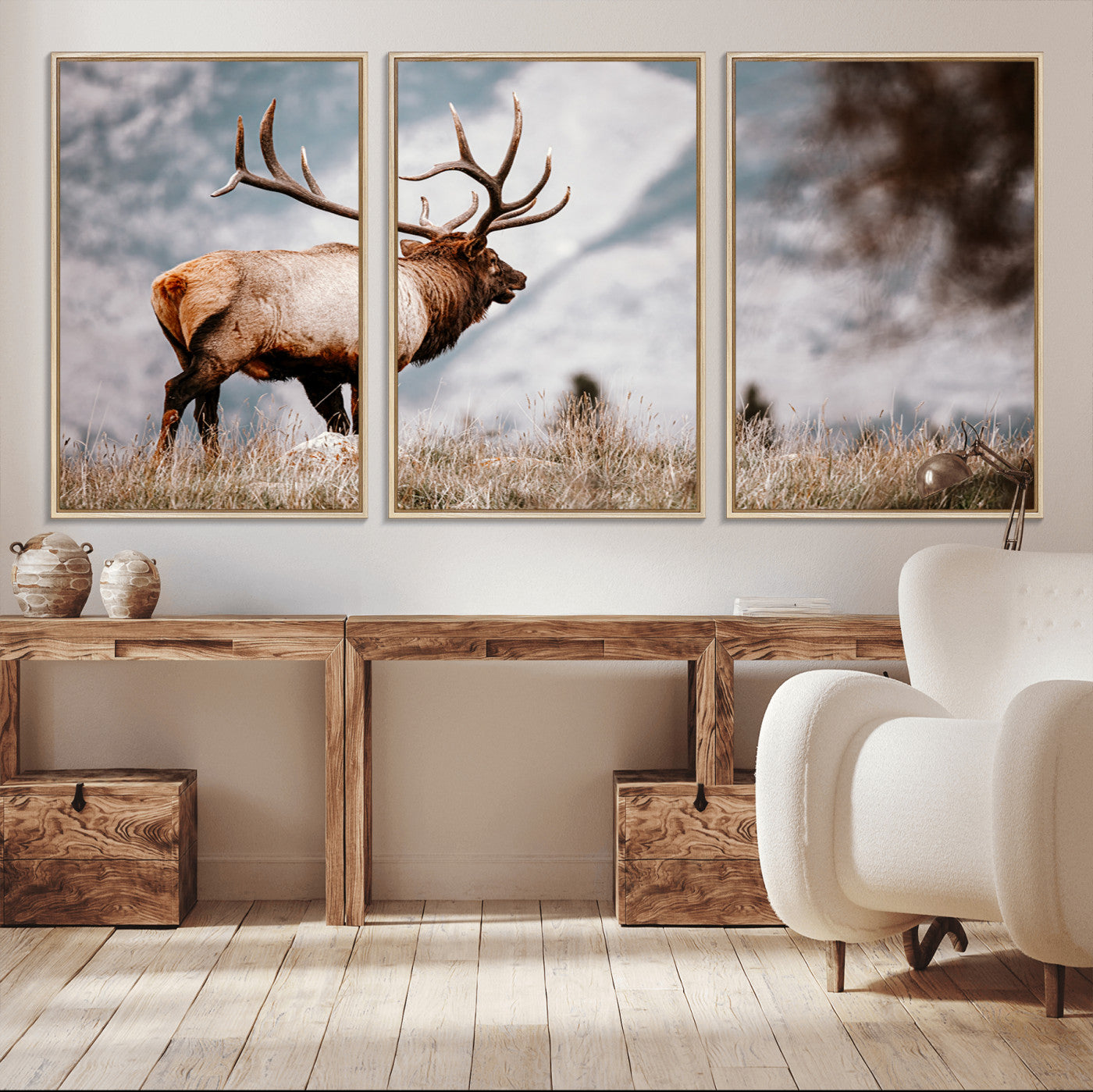 Majestic elk with large antlers standing in grass with snowy mountains in background, perfect for rustic cabin or lodge style decor.