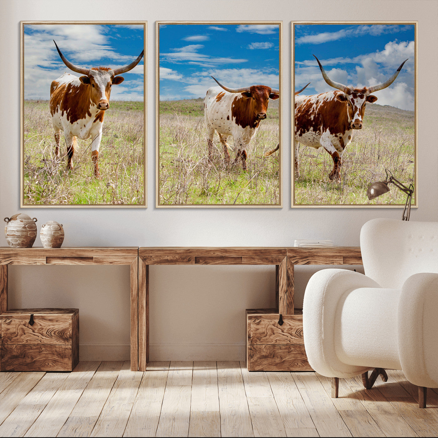 Three Texas longhorn cattle standing in dry grass under a bright blue sky, ideal for farmhouse or western rustic home decor.