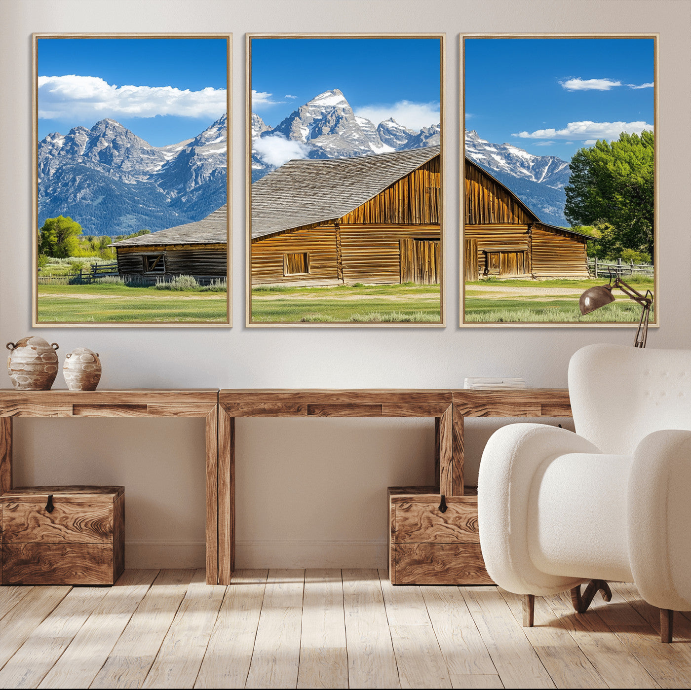 A rustic wooden barn sits in front of towering mountain peaks under a clear blue sky, perfect for farmhouse or cabin style interiors.