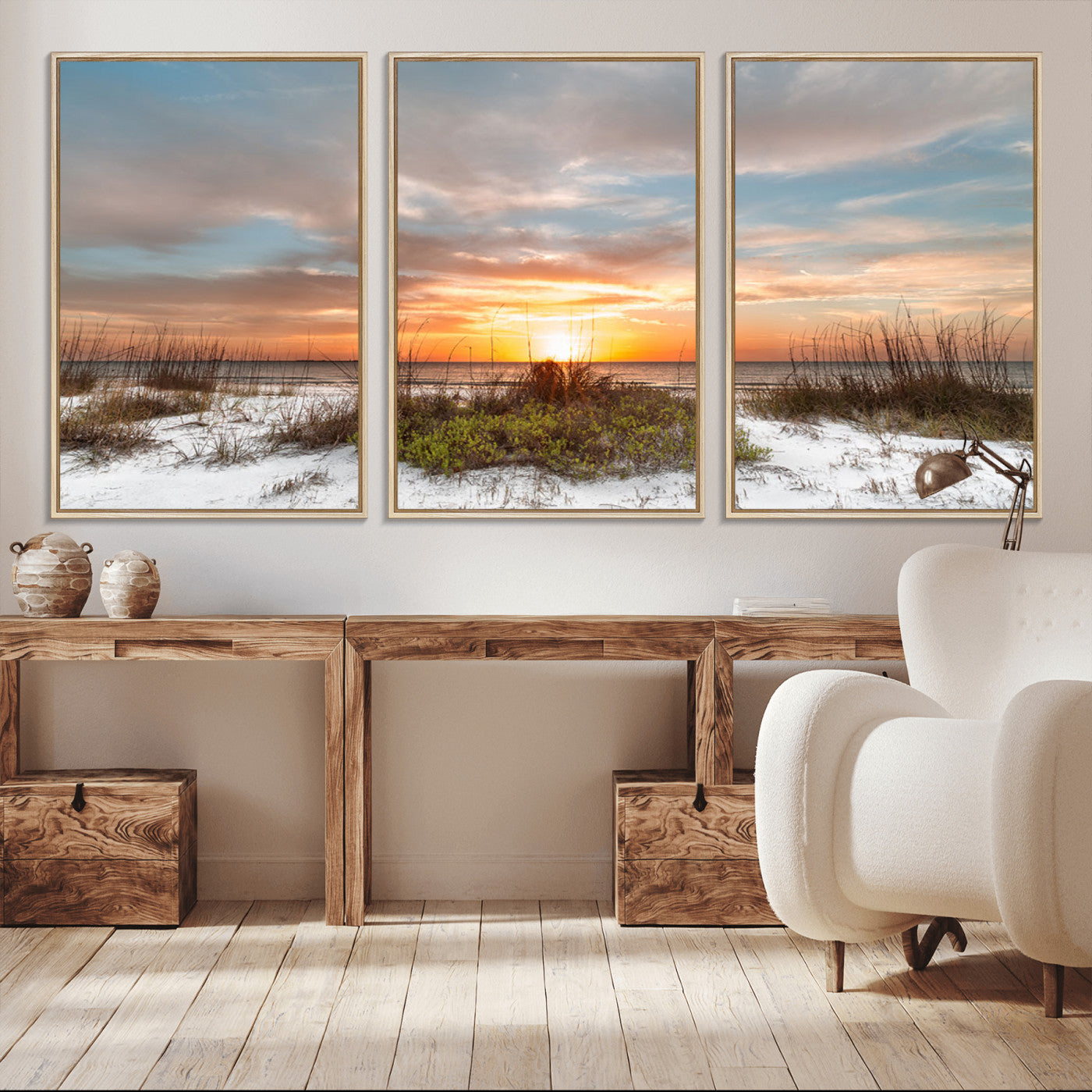 A tranquil beach scene featuring golden sunset hues over the water, with grasses in the foreground and a peaceful, serene atmosphere.
