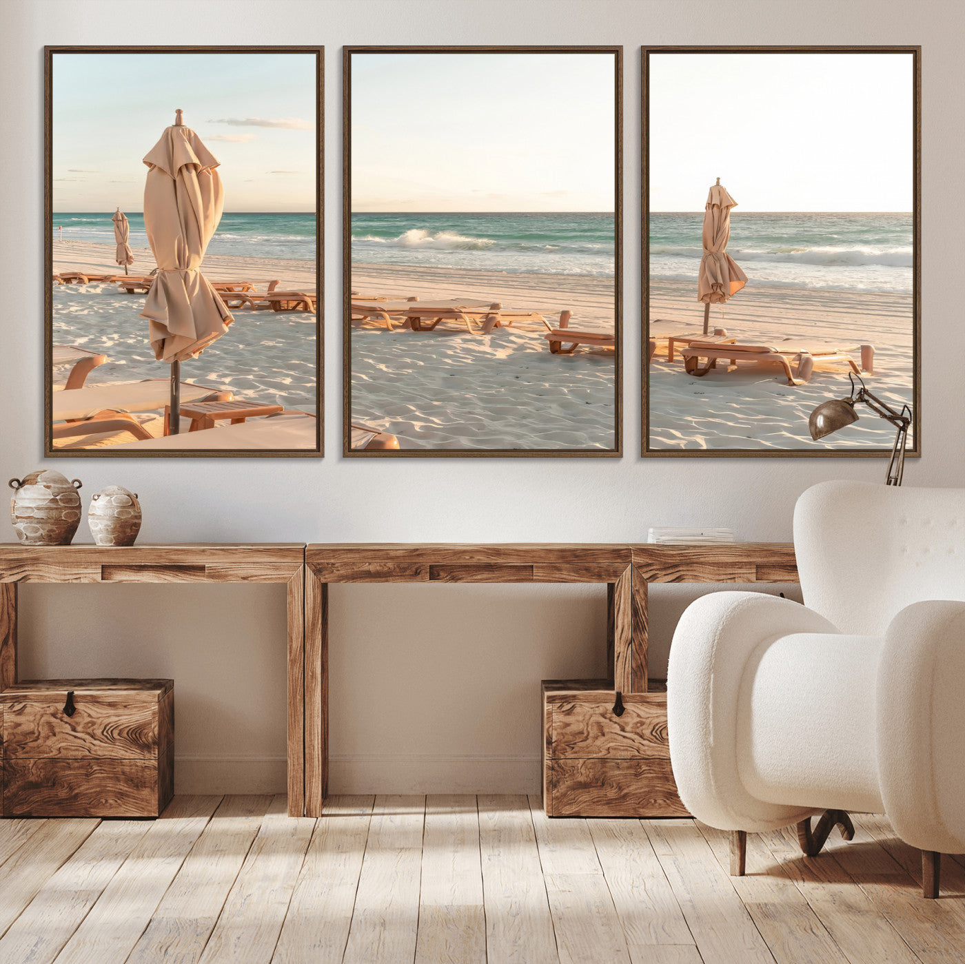 Minimalist photo of empty beach loungers and umbrellas on soft sand, ideal for calm seaside or pastel coastal-style home decor.