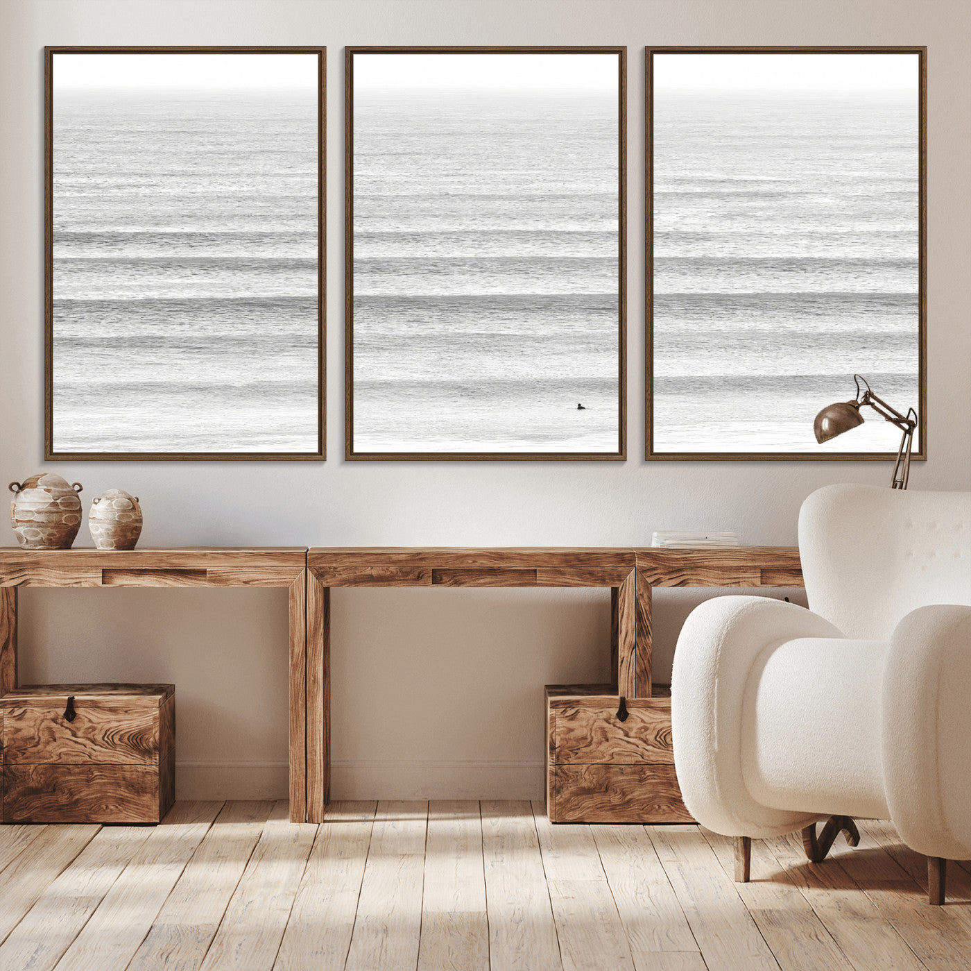 Monochrome photo of a lone surfer in calm layered waves, perfect for minimalist coastal or moody ocean-inspired wall decoration.