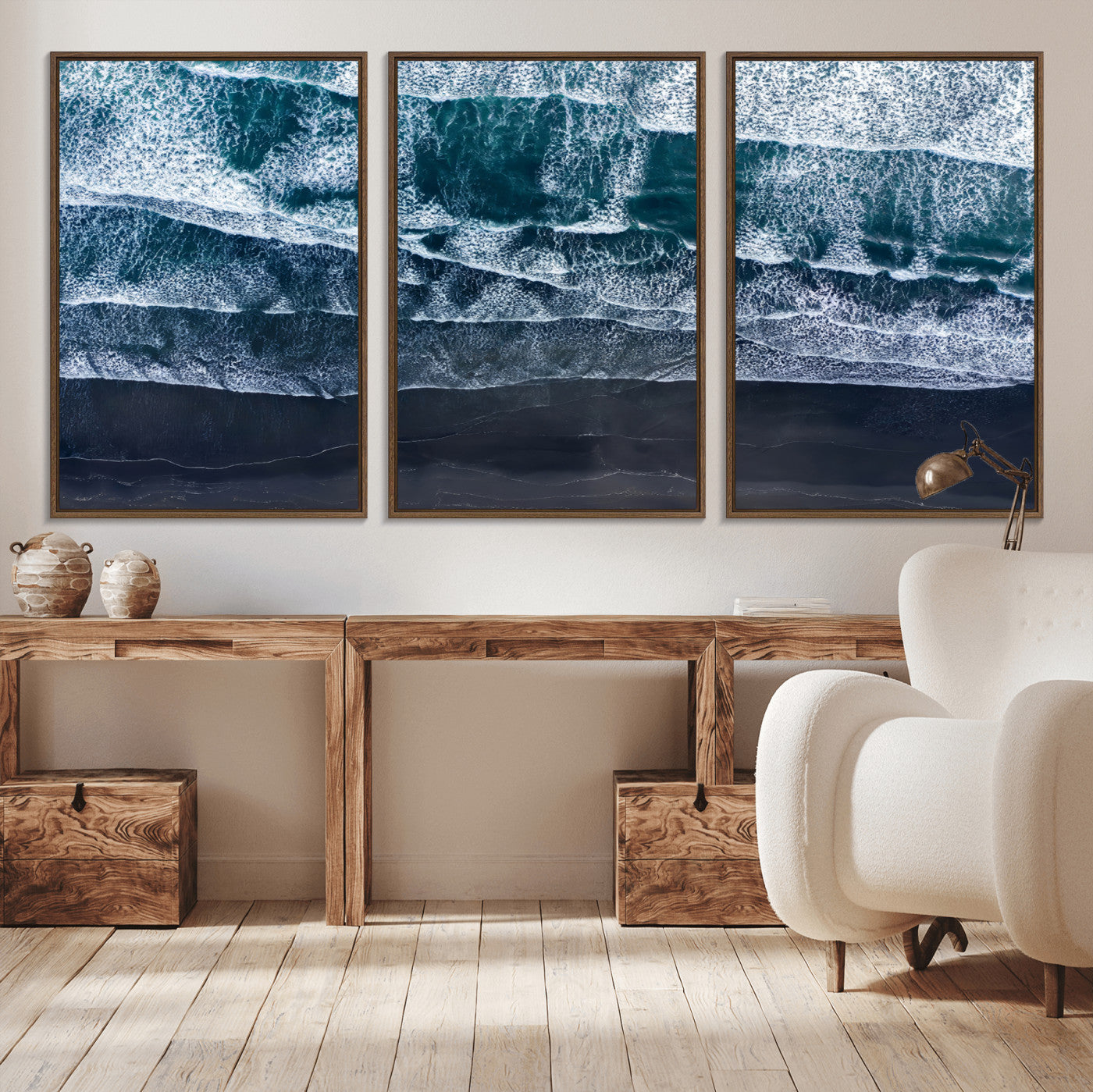 Canvas of aerial ocean waves crashing onto a black sand beach in moody tones, ideal for modern coastal or minimalist home decor.