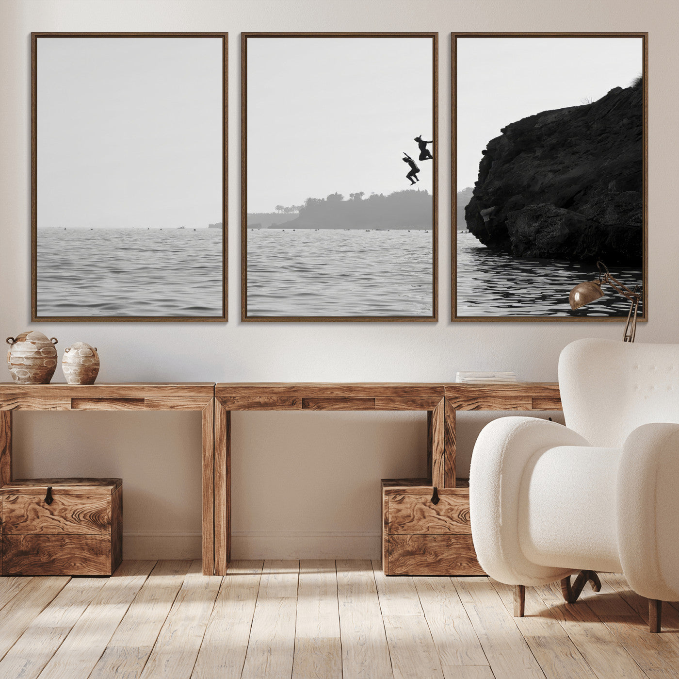 Black and white canvas of two figures cliff jumping into the sea, captured with moody tones, ideal for modern coastal or adventure-themed home decor. 2/2