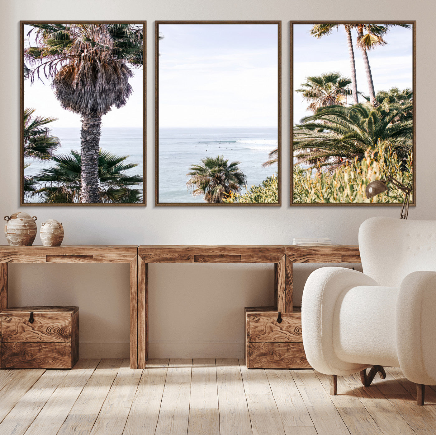 Scenic coastal view with tall palm trees overlooking a calm ocean, soft blue waves, and surfers in the distance, creating a peaceful tropical vibe.